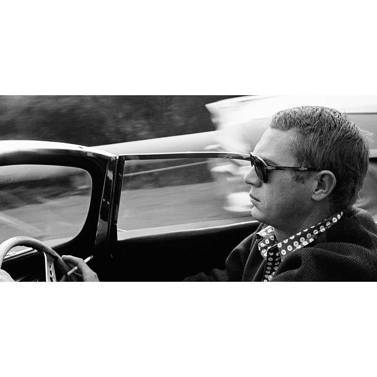 Sid Avery Black and White Photograph - Steve McQueen driving his 1957 XK-SS Jaguar through Nichols Canyon in Hollywood