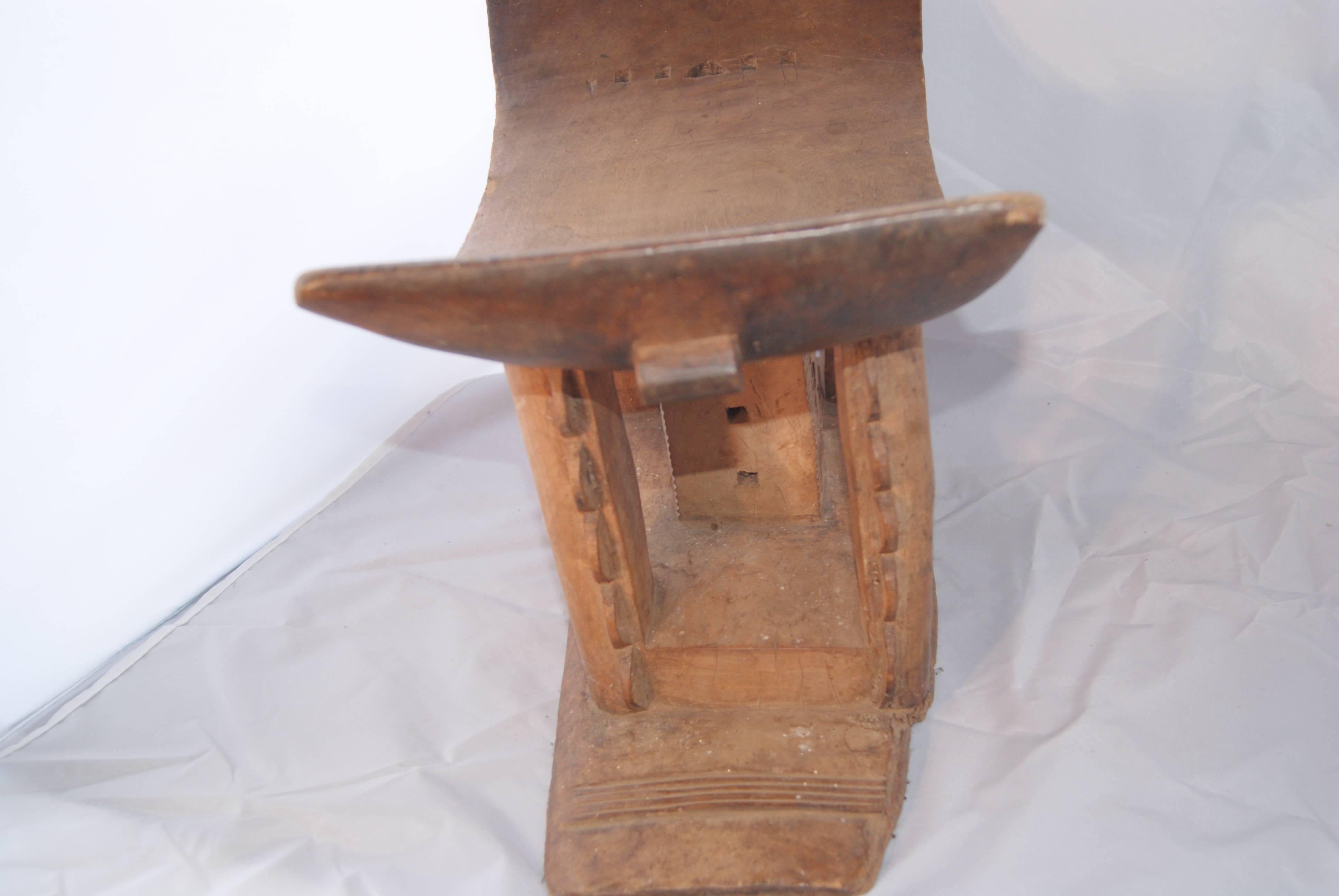 Stools indicate status, power, and the succession of chiefs and kings.  The Asante (or Ashanti) stool is carved from a single block of wood and has a crescent-shaped seat, flat base and an intricate support structure, which is typical.  Asante