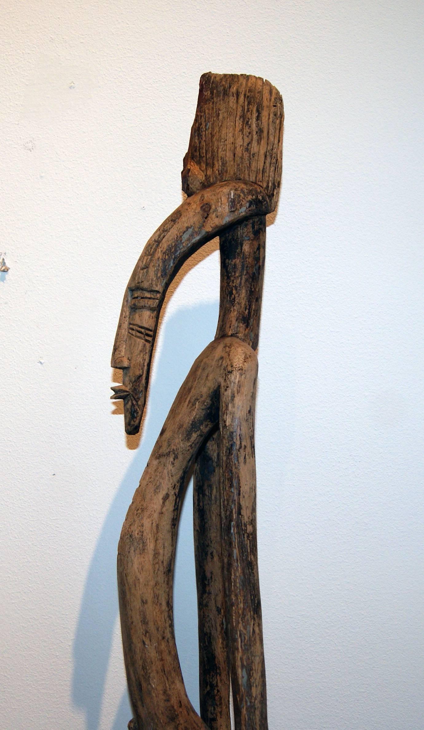 This is a wood carving of a man from the Senufo people of the Ivory Coast in Africa.