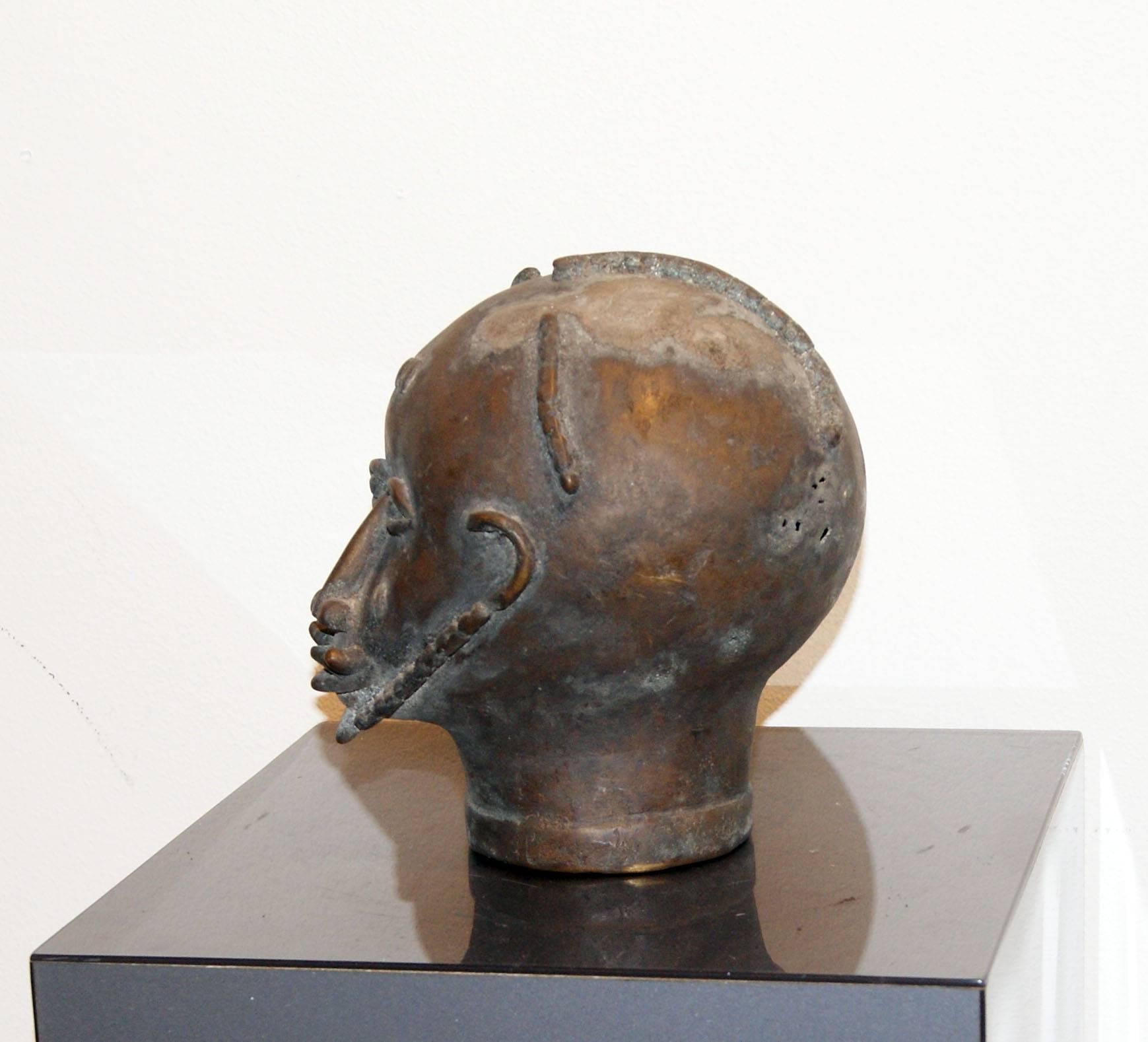 This is a very old bronze sculpture of a head from the Asante tribe in Africa.

