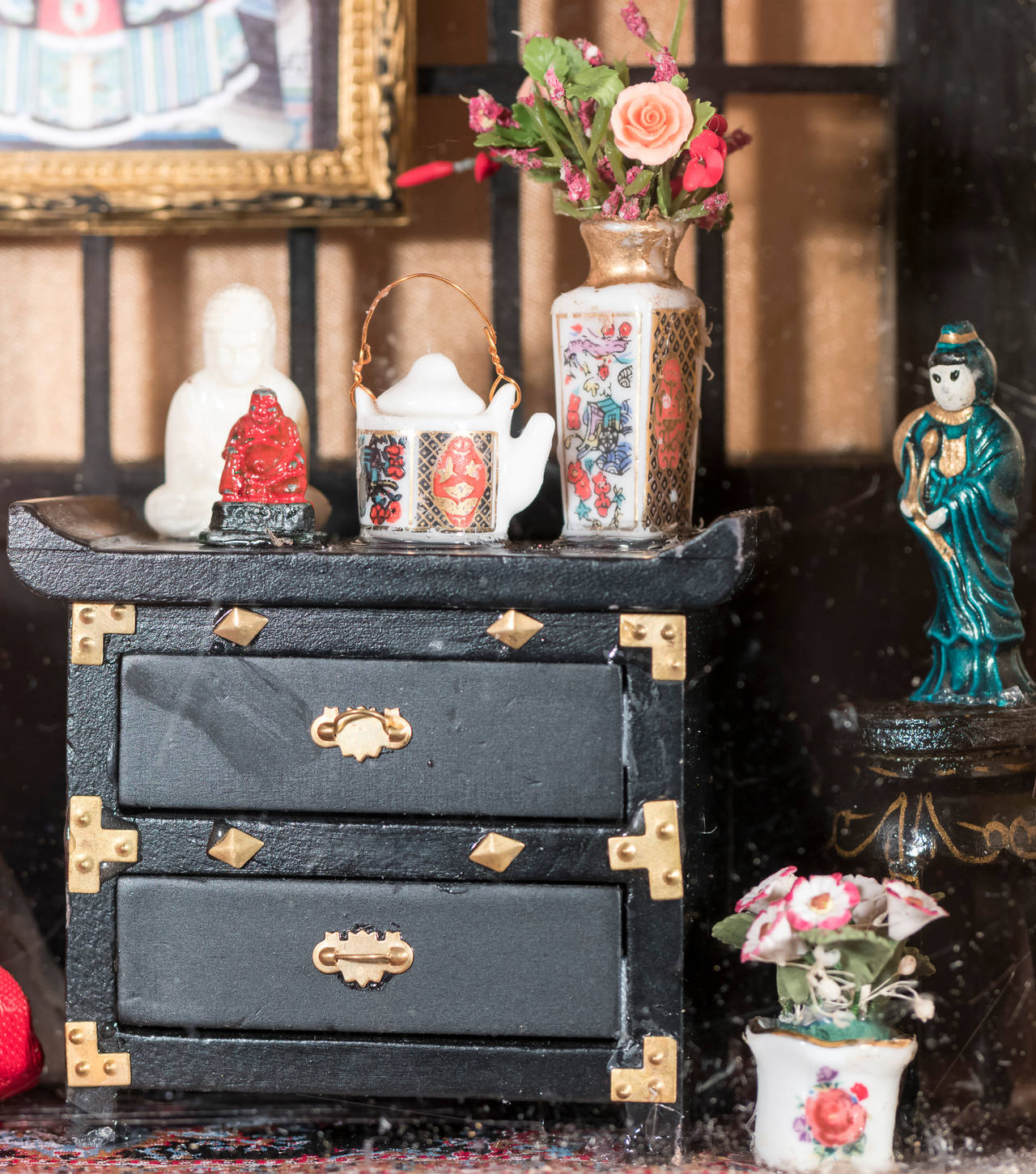 Shadow Box by New York diorama artist Bonnie Schewkes. Features antique Japanese doll in traditional costume with fan. Room is decorated with framed ancestor portrait, a Shoji screen, porcelain vases and plates, a framed mirror on the left wall and