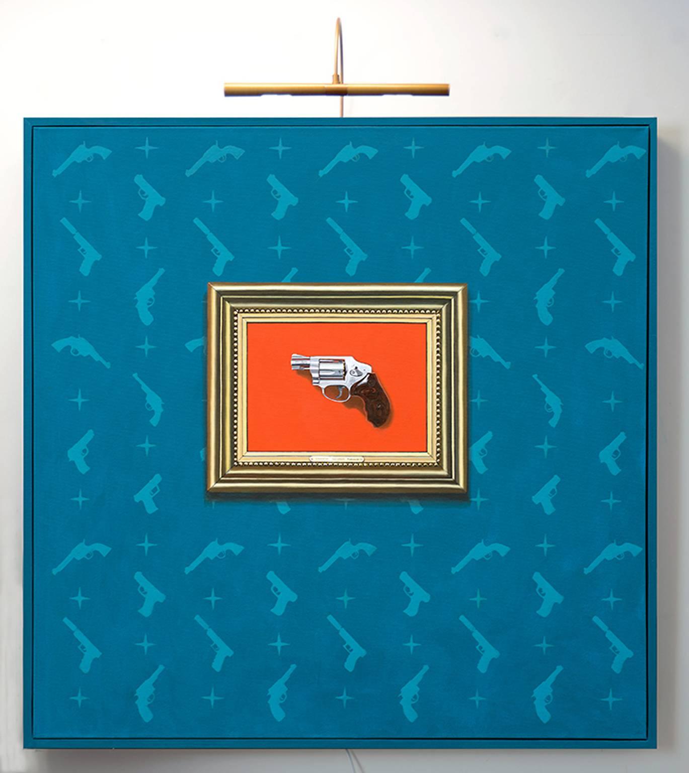 "The Armory Show" by Gordon Lee features a painting of a gun on a orange background in an ornate painted frame "hanging" on a blue background with a pattern of contrasting blue guns.  There is a functional light mounted to the top of the piece which