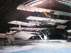 Photorealist painting airplane hangar, "Residue", oil on linen