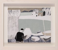 A fisherman by his boats on the beach