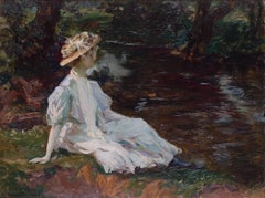 Young beauty resting on the riverbank