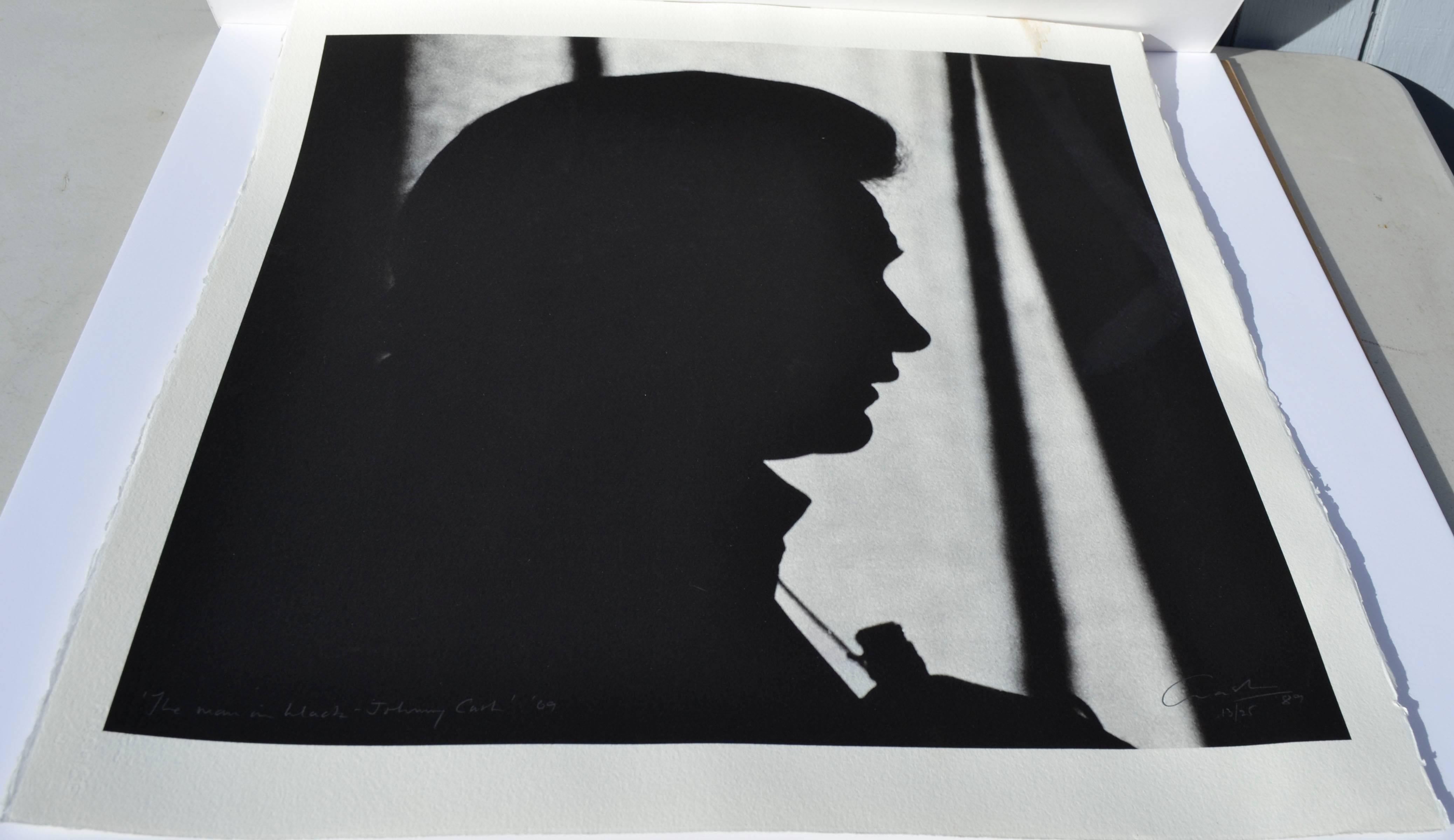 A silhouette portrait of iconic music legend Johnny Cash titled 