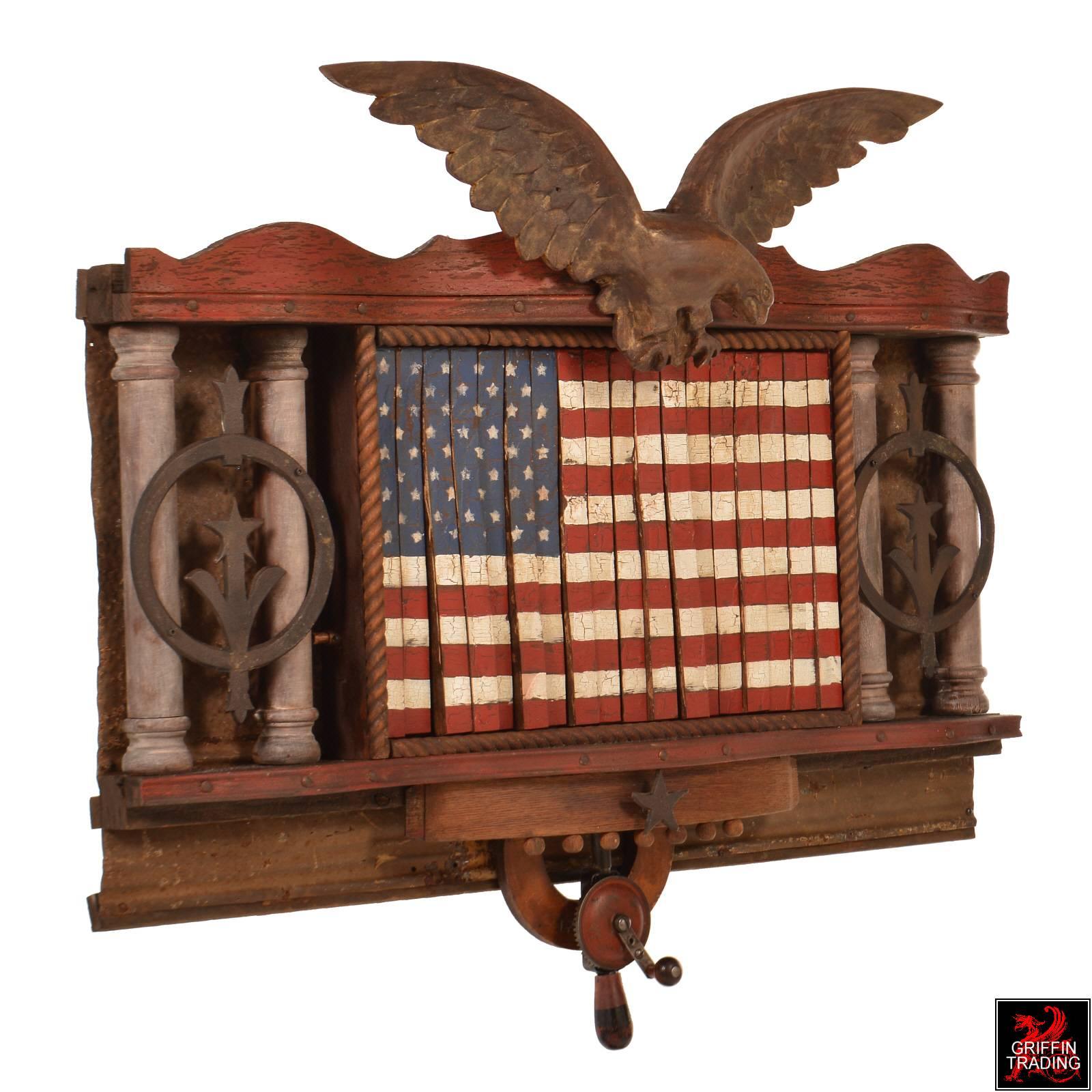 Standing guard over Old Glory, this hand-carved Eagle with 25″ wingspan is just one of the many components and features that make up this unique Folk Art wall hanging. The most amazing part of this one-of-a-kind artwork is its mechanical waving