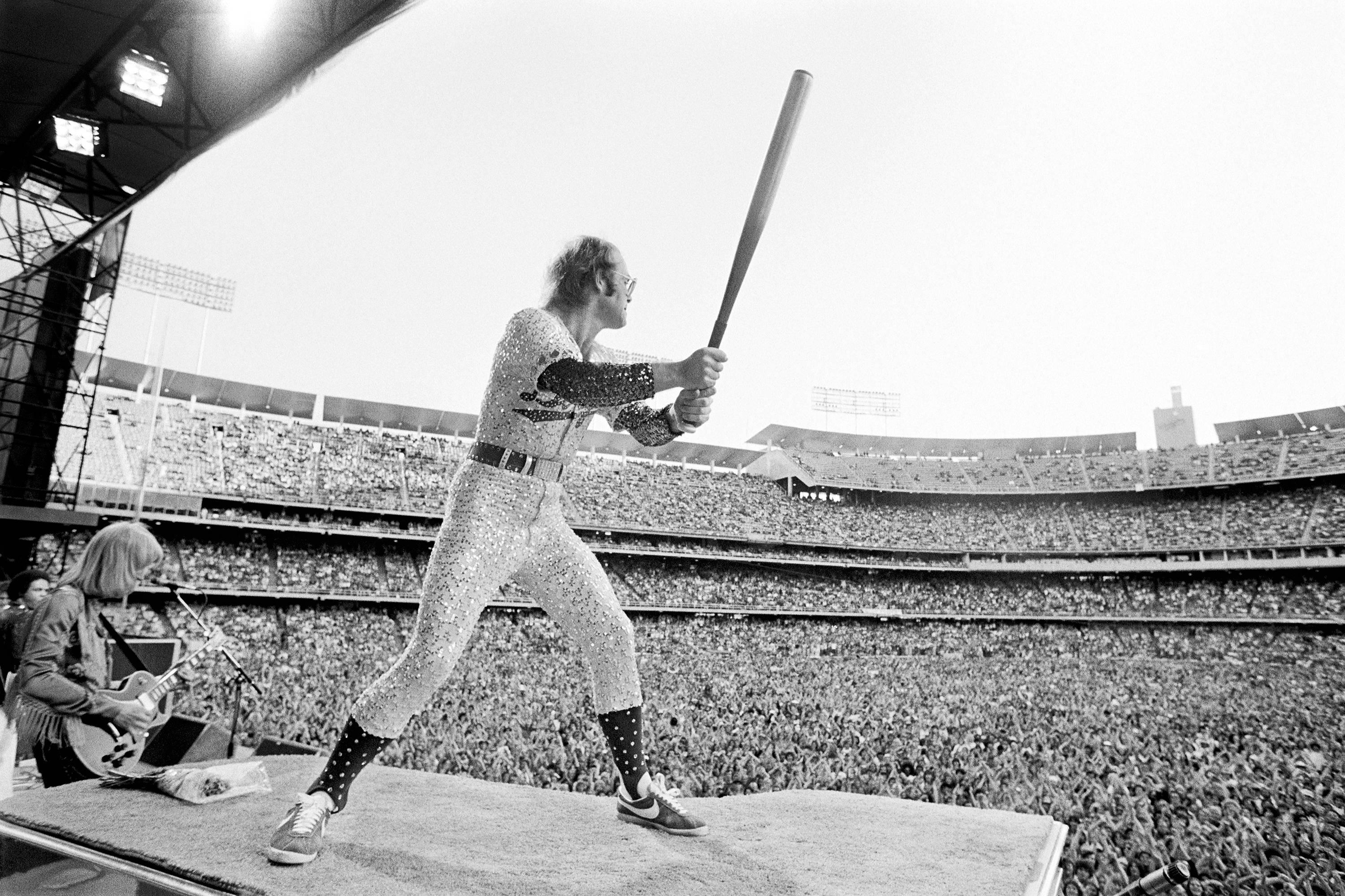 Terry O'Neill Figurative Photograph - Elton at Dodgers stadium. 