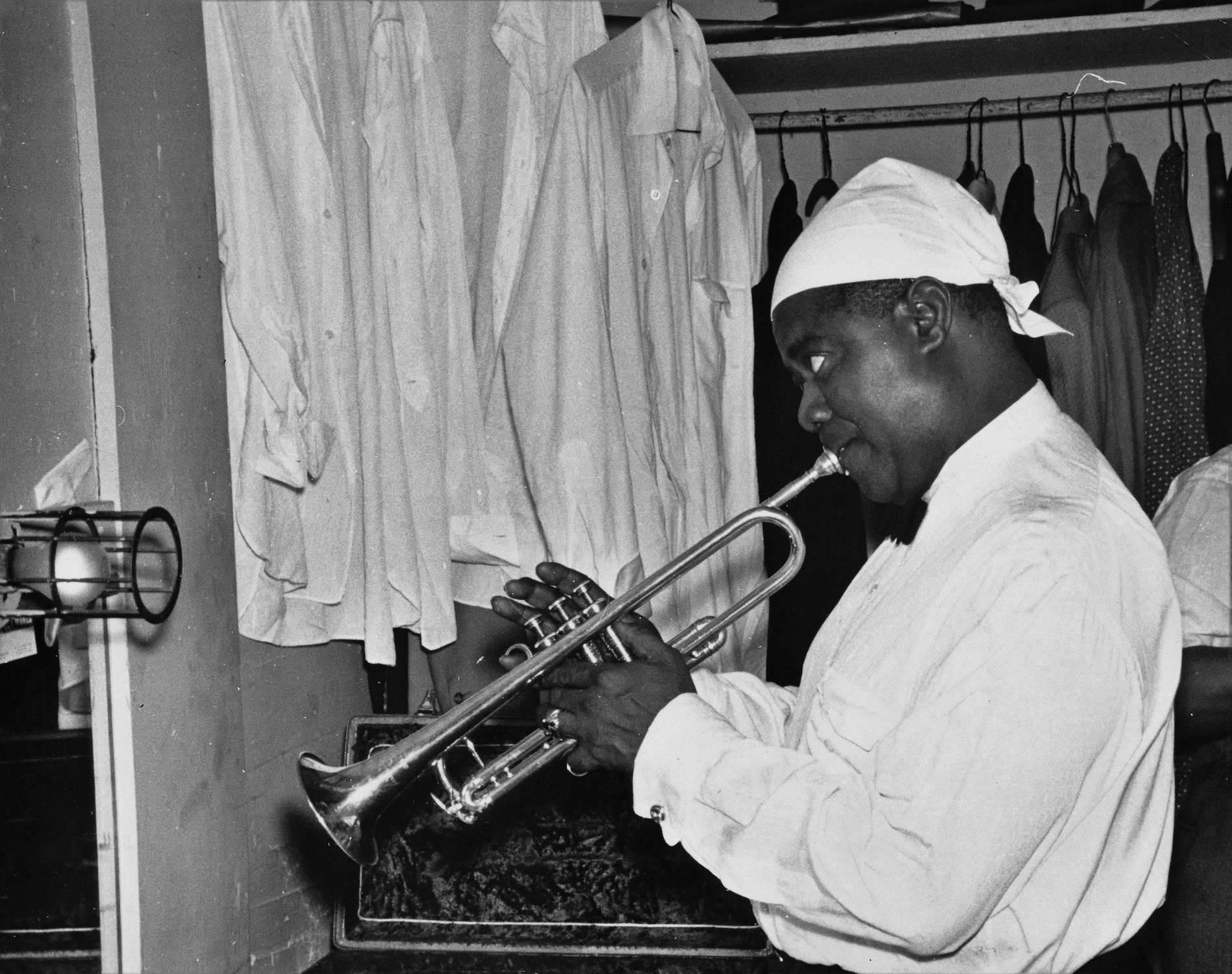 Weegee Black and White Photograph - Louis Armstrong Practicing Backstage Fine Art Print