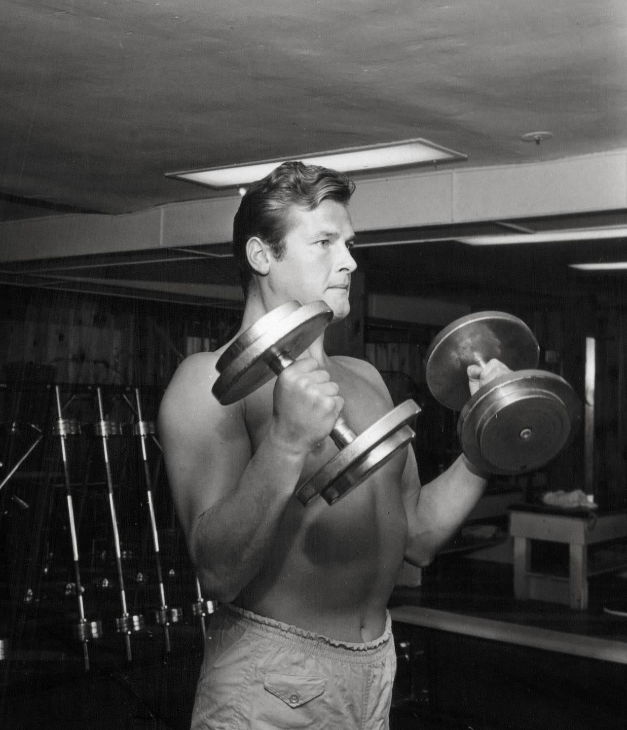 Larry Barbier Portrait Photograph - Shirtless Roger Moore Pumping Iron Fine Art Print