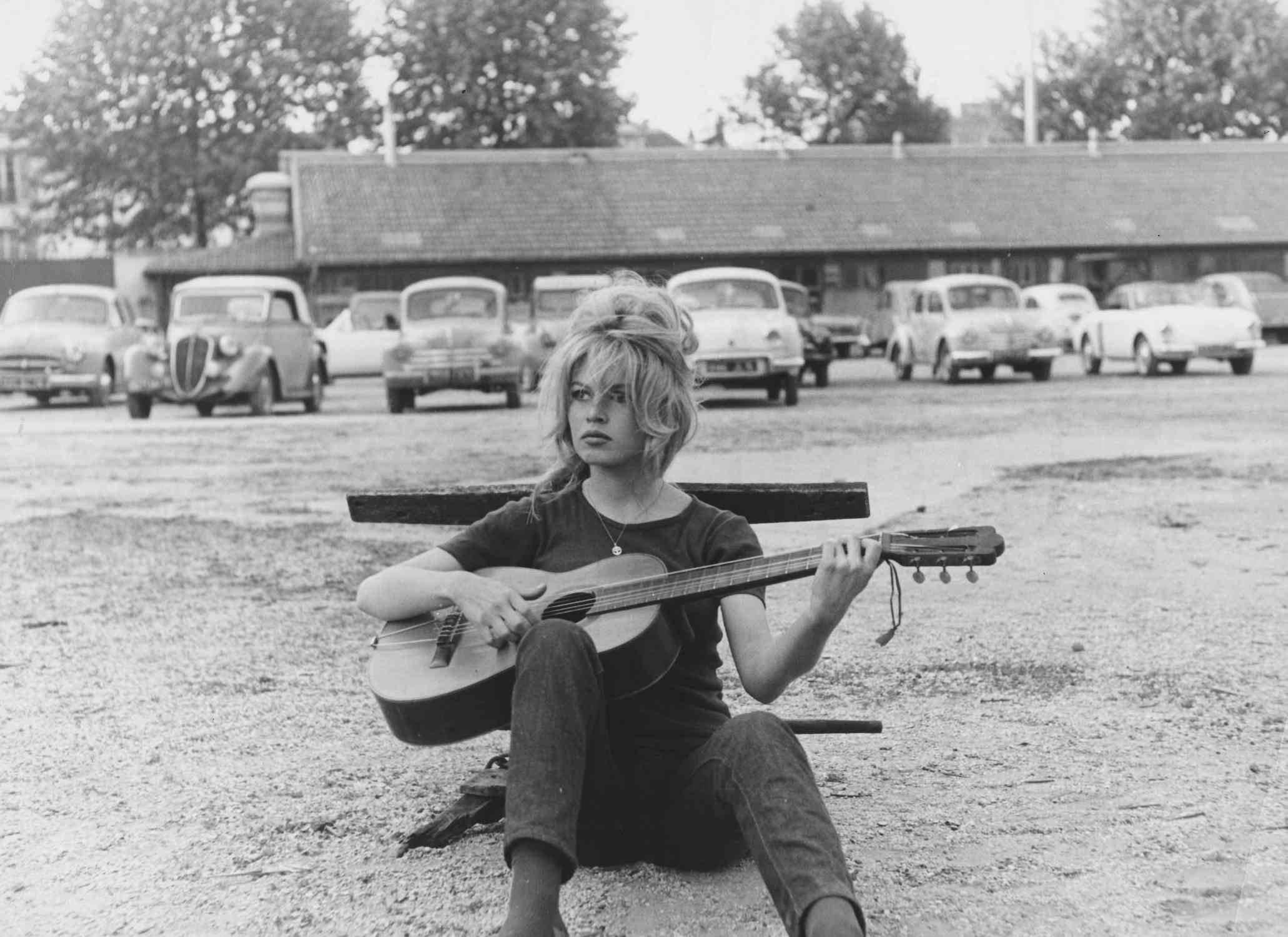 Unknown Black and White Photograph - Brigitte Bardot Playing Guitar Fine Art Print
