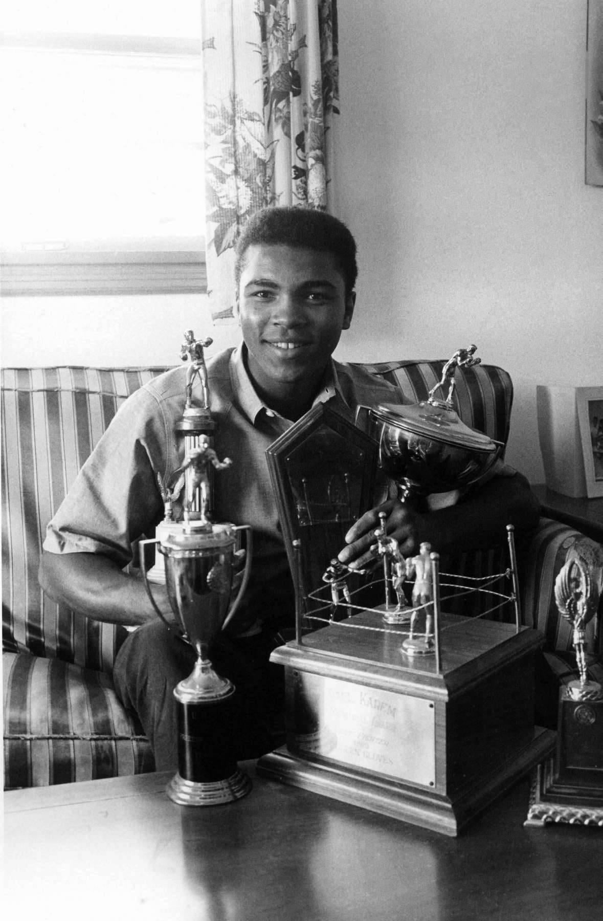 Unknown Portrait Photograph - Muhammad Ali Posed With His Trophies Fine Art Print