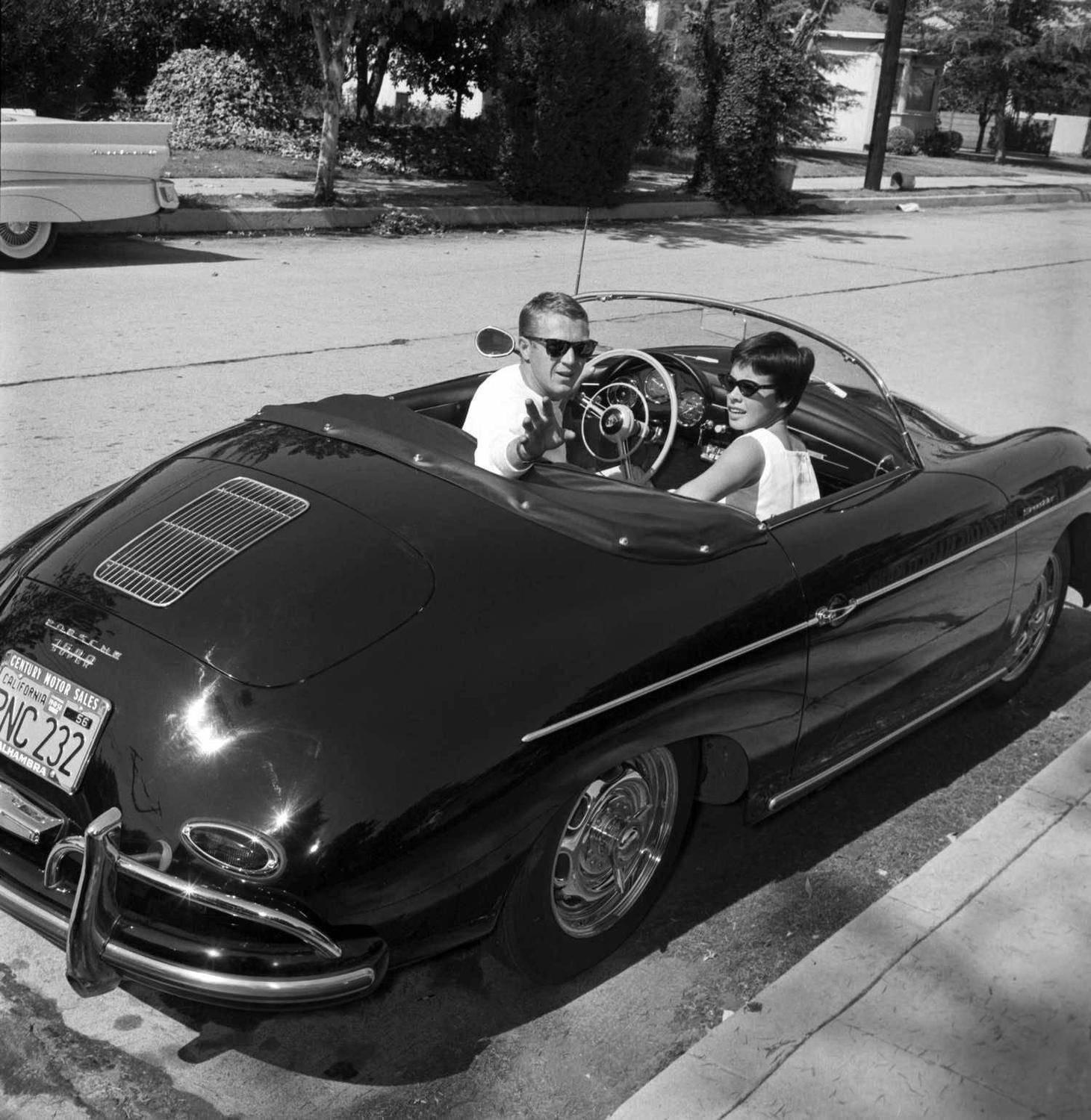 Larry Barbier Black and White Photograph - Steve McQueen and Neile Adams in 1961 with his beloved Porsche
