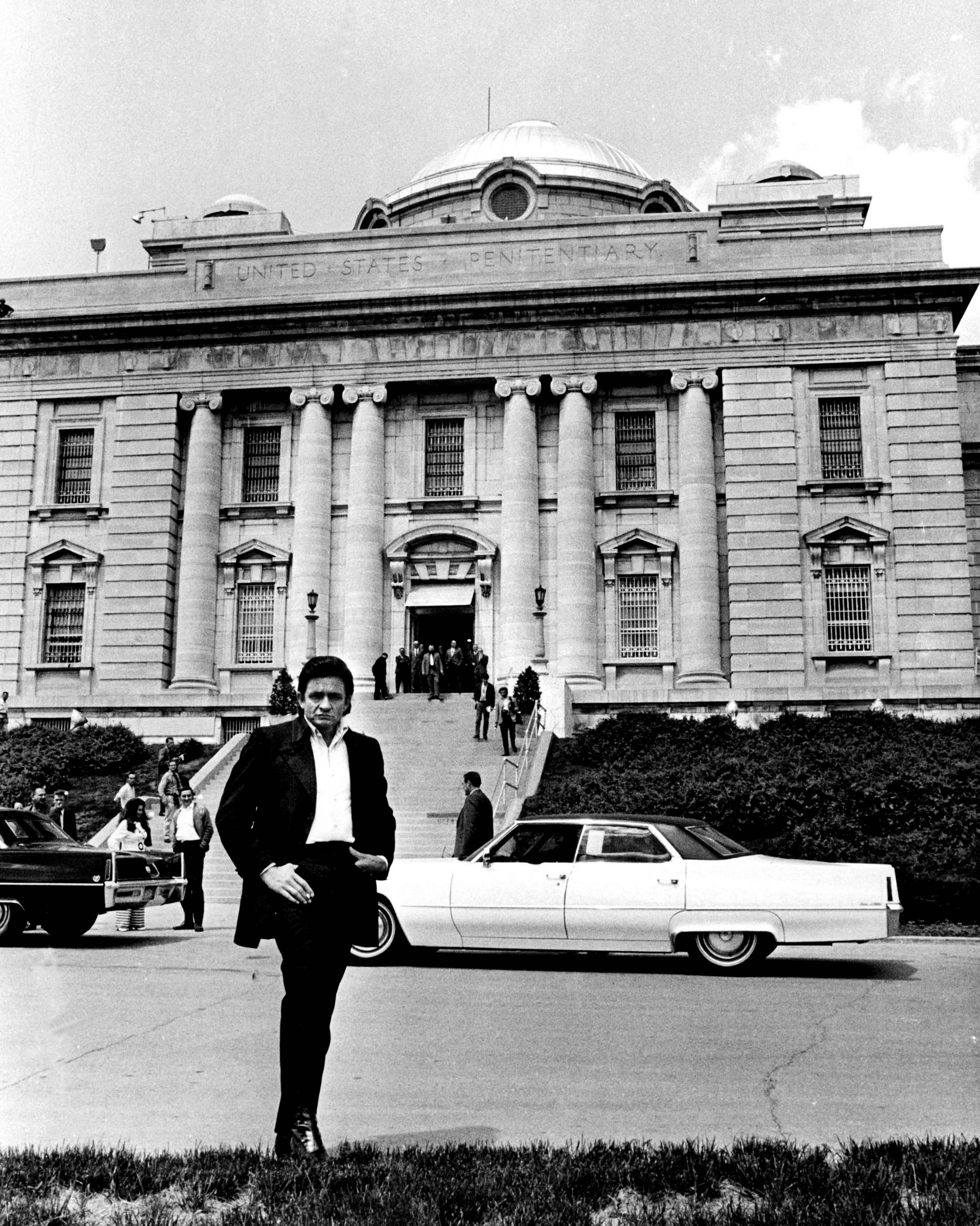 J.T. Phillips Black and White Photograph - Johnny Cash in Front of Folsom Prison Fine Art Print