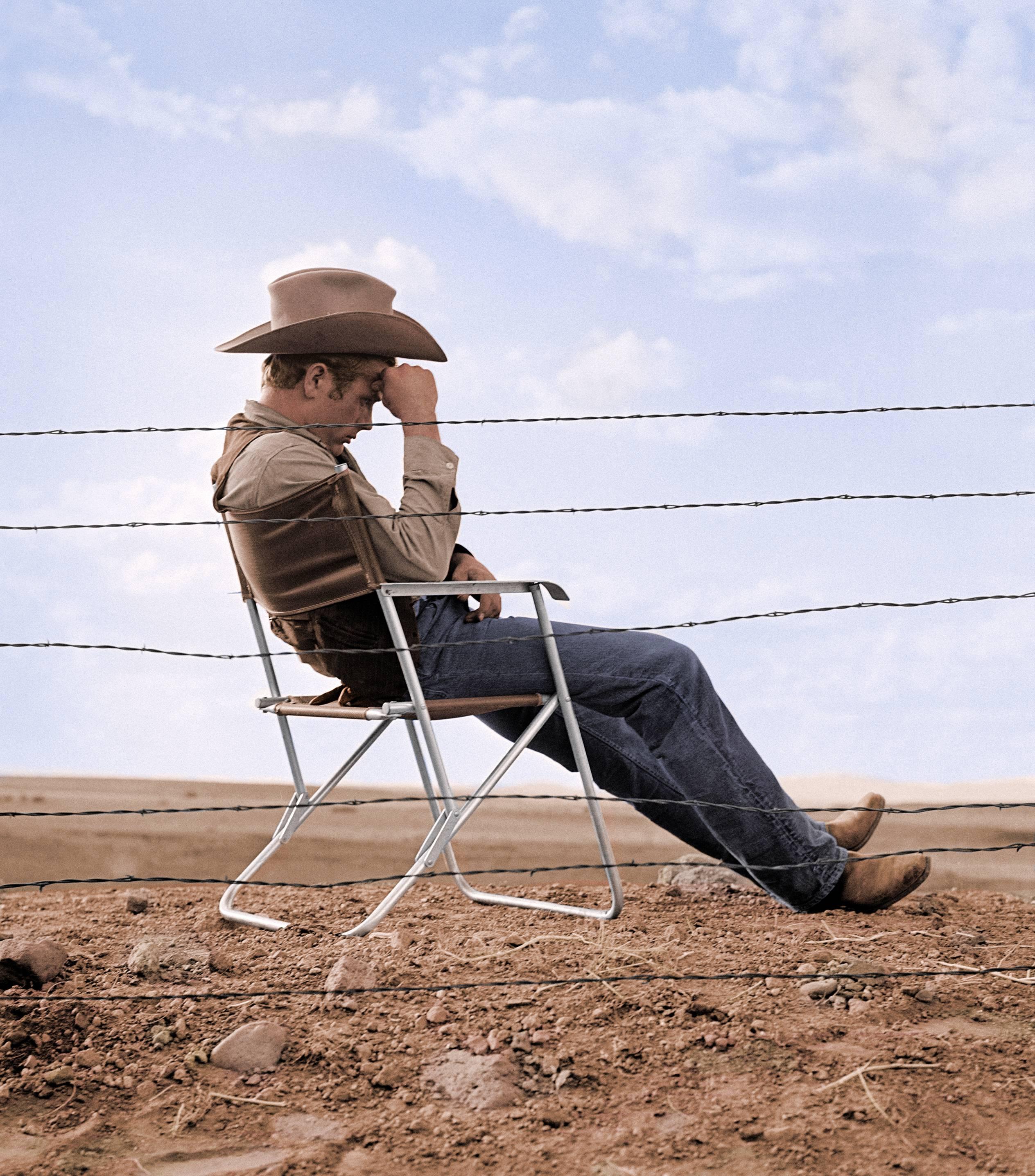 Frank Worth Portrait Photograph - James Dean Seated Behind Fence on the Set of "Giant" - Colorized Fine Art Print