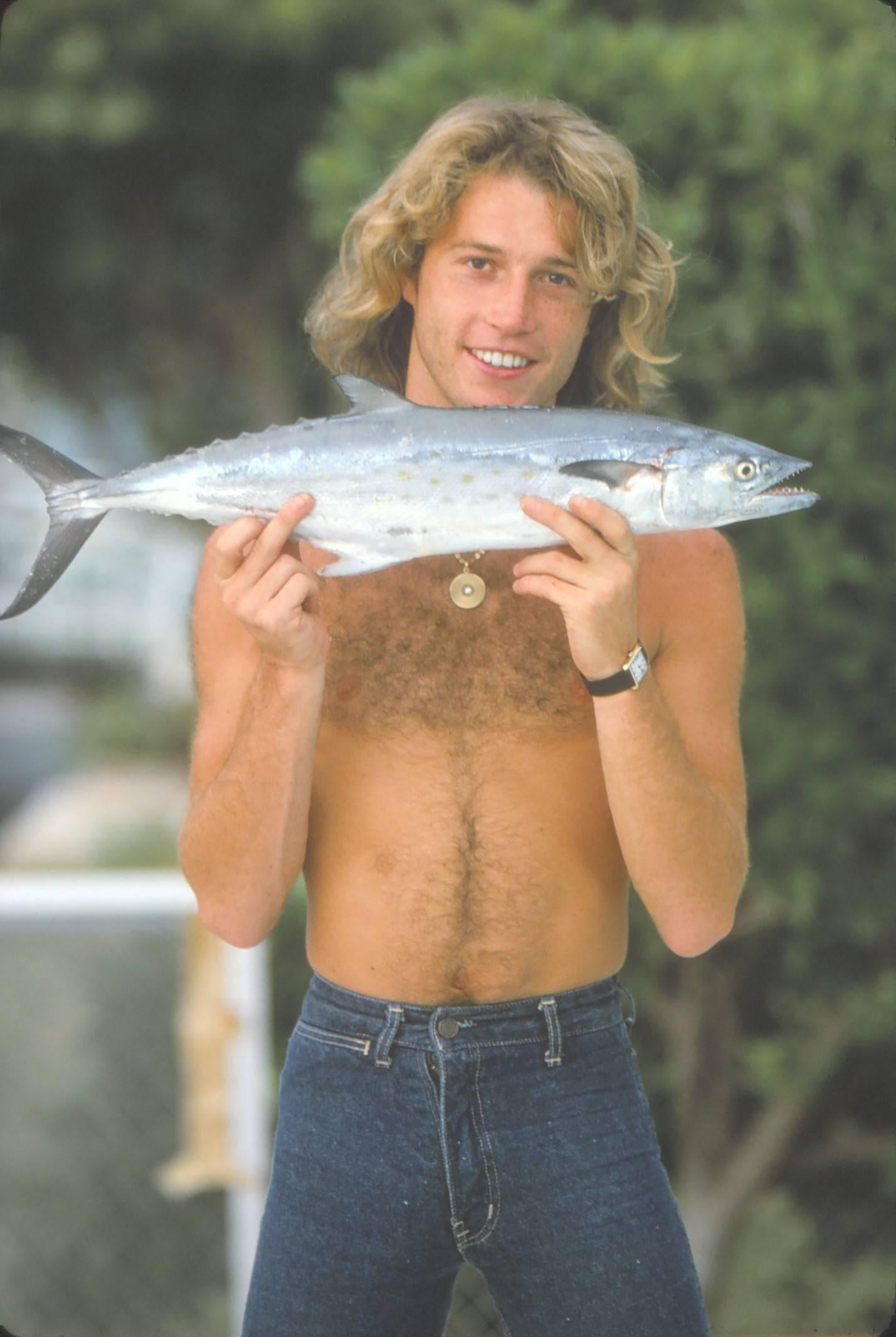 Unknown Portrait Photograph - Andy Gibb Catching a Fish Fine Art Print