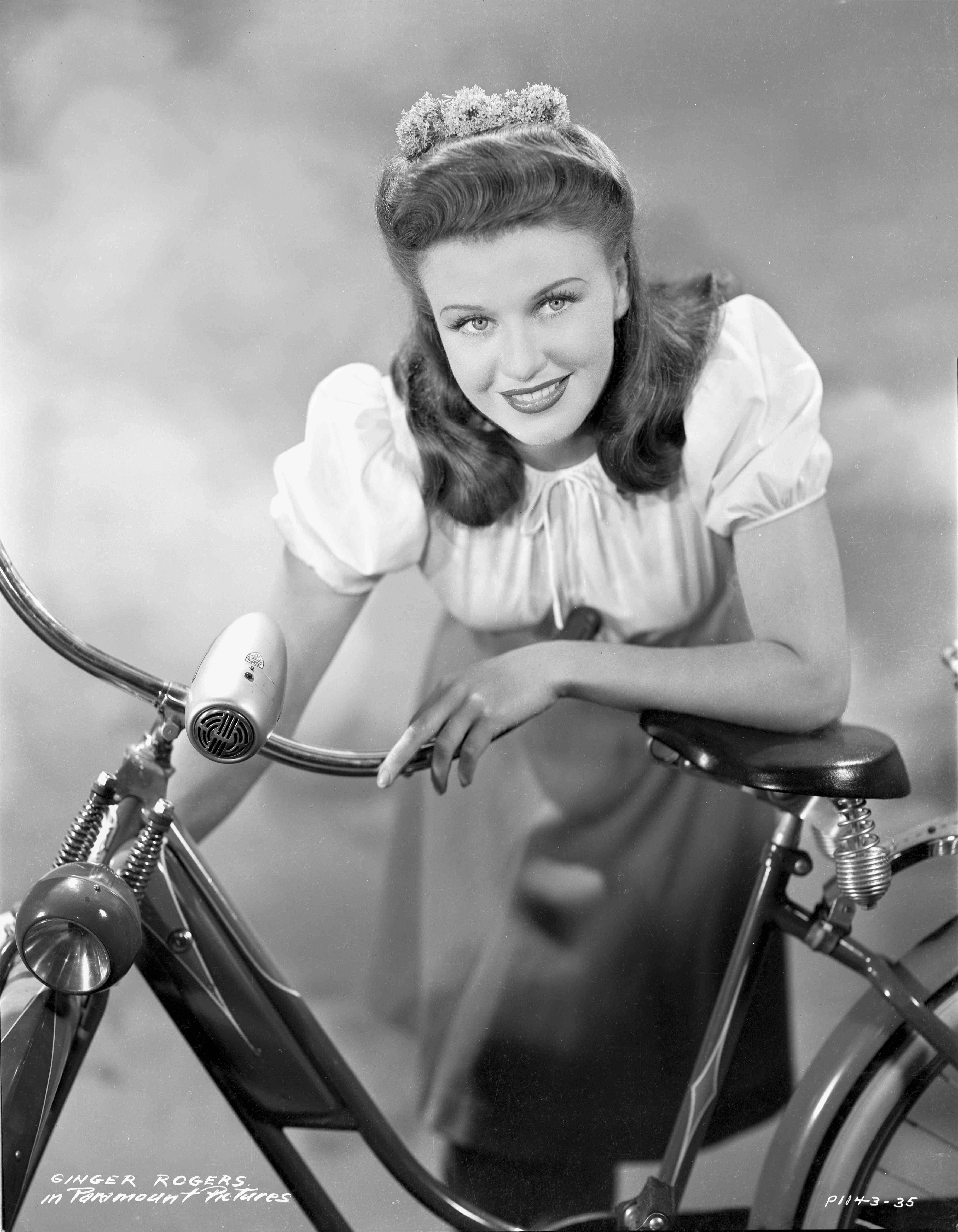 Hal Mcalpin Black and White Photograph - Ginger Rogers Leaning on Bike Fine Art Print