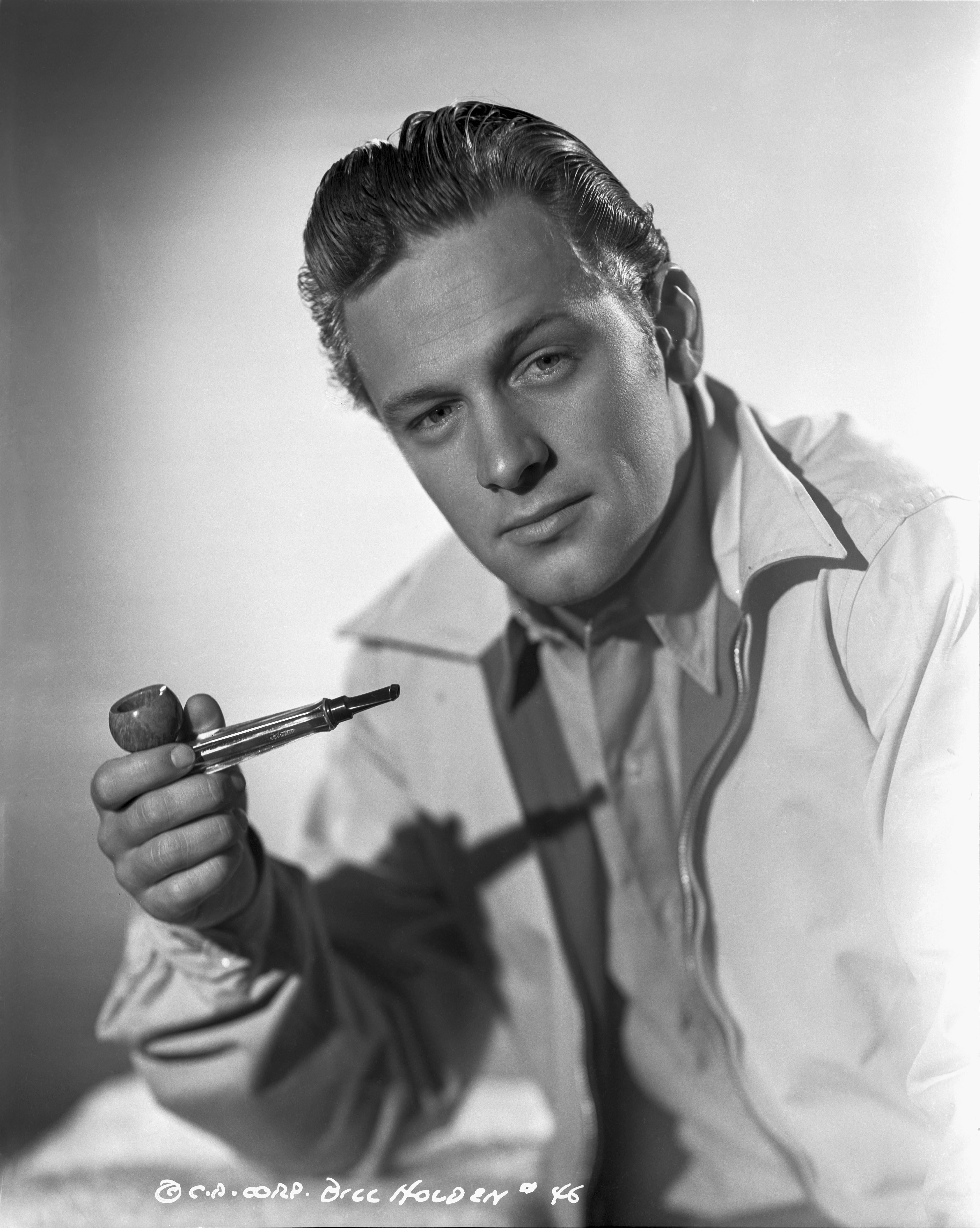 A.L. Whitey Schafer Black and White Photograph - William Holden Holding Pipe Fine Art Print