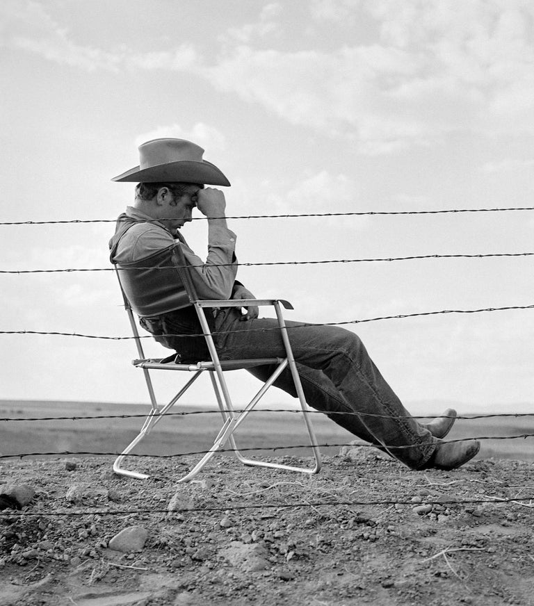 Frank Worth Black and White Photograph - James Dean Seated Behind Fence on the Set of "Giant" Fine Art Print
