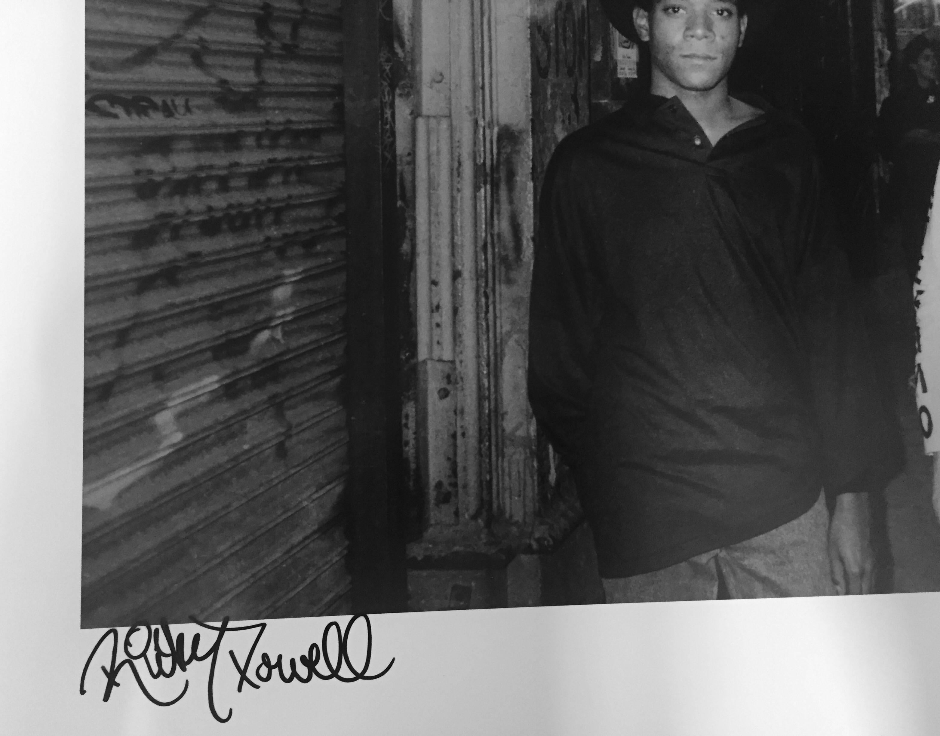 Ricky Powell took this photograph of Warhol and Basquiat on Mercer Street, in 1985, as the two were on their way to the opening of an exhibition of their Collaboration paintings at Tony Shafrazi Gallery.   

Ricky Powell was born and raised in New