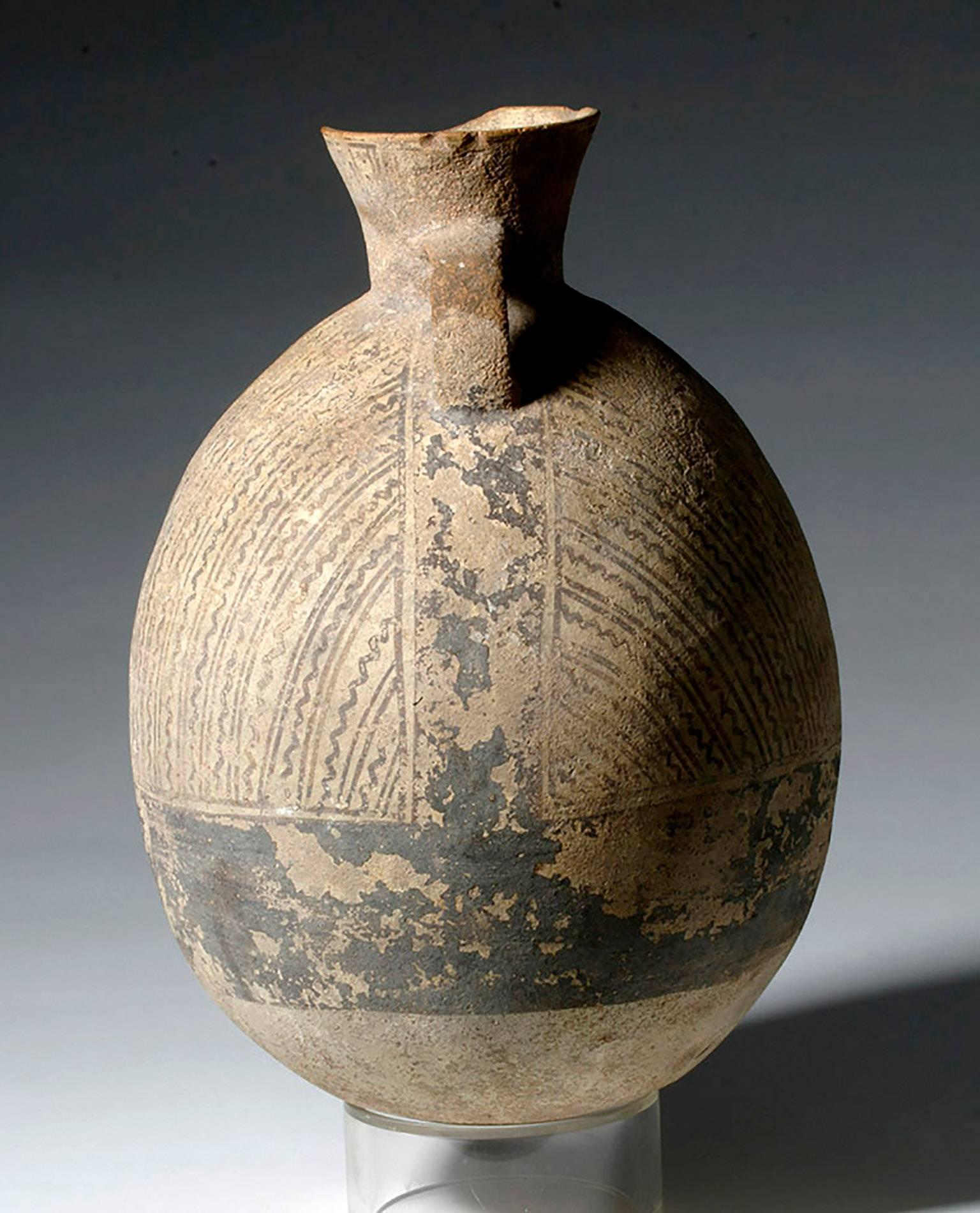 Large Pre-Columbian Pottery, Chancay culture, Peru, ca. 1200 to 1450 CE. This is a large round olla in the classic Chancay style, with linear decorations and a wide dark band painted around the base. There is an animal with four legs, prominent