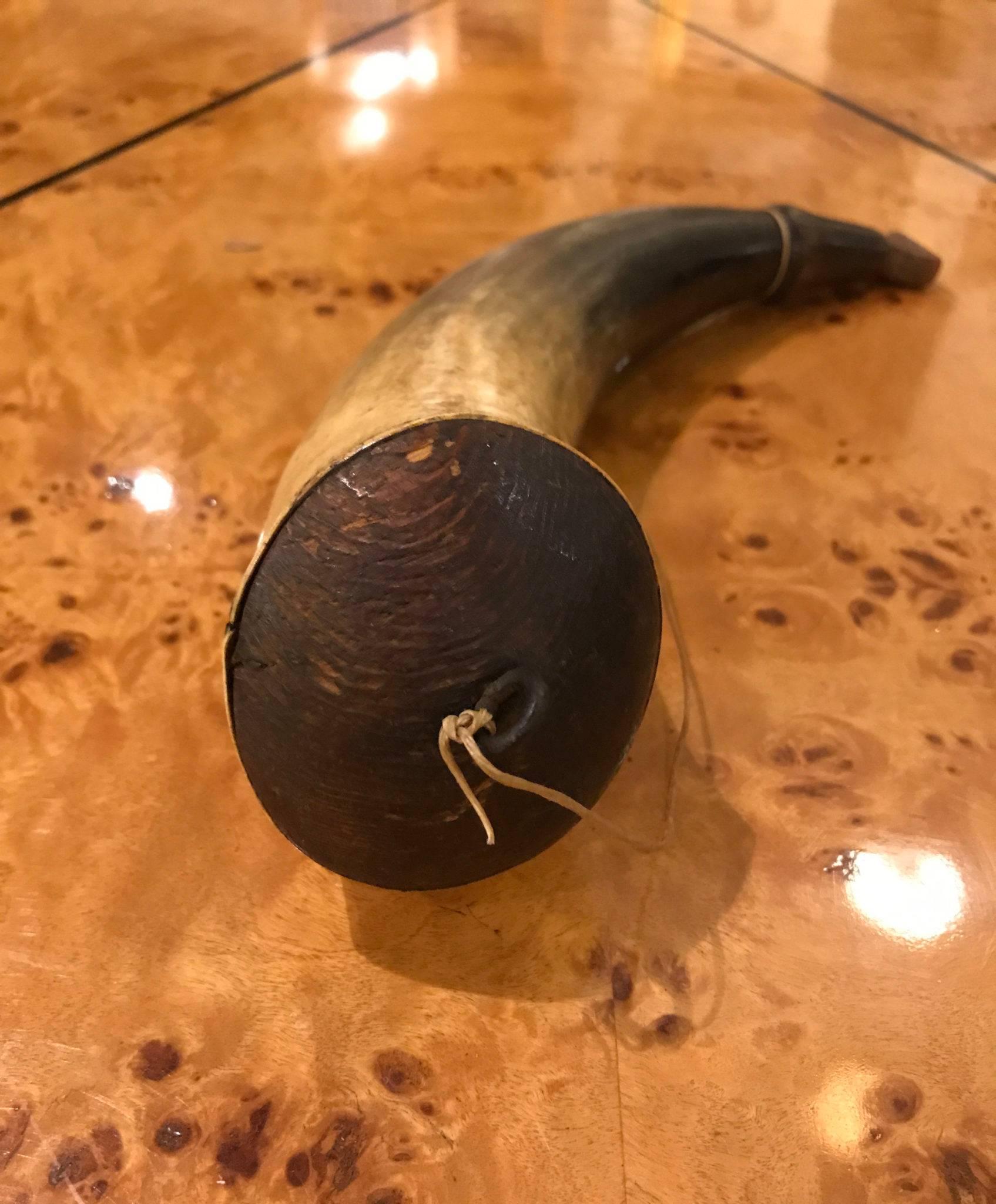 Impressive Powder Horn from late 18th century or early 19th century  Horn has well carved spout with groove for strap, a well fitted wood end cap with a round wire ring on the end cap for strap attachment, and a very nice carved wood stopper 