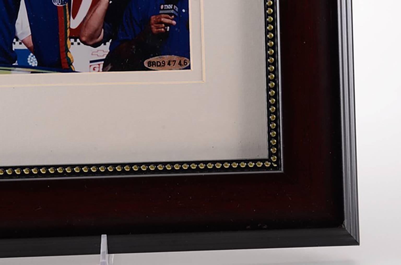 Unique framed Jeff Gordon racing photograph hand signed by Jeff Gordon in blue marker  The autograph has been professionally authenticated by Upper Deck with sticker hologram affixed to the photo  An accompanying Upper Deck certification is enclosed