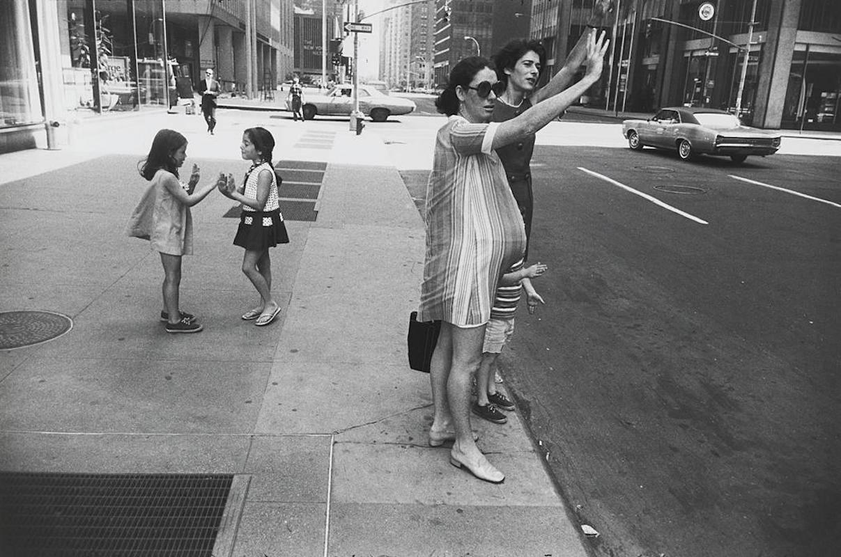Garry Winogrand Black and White Photograph - New York, (two women hailing cab)