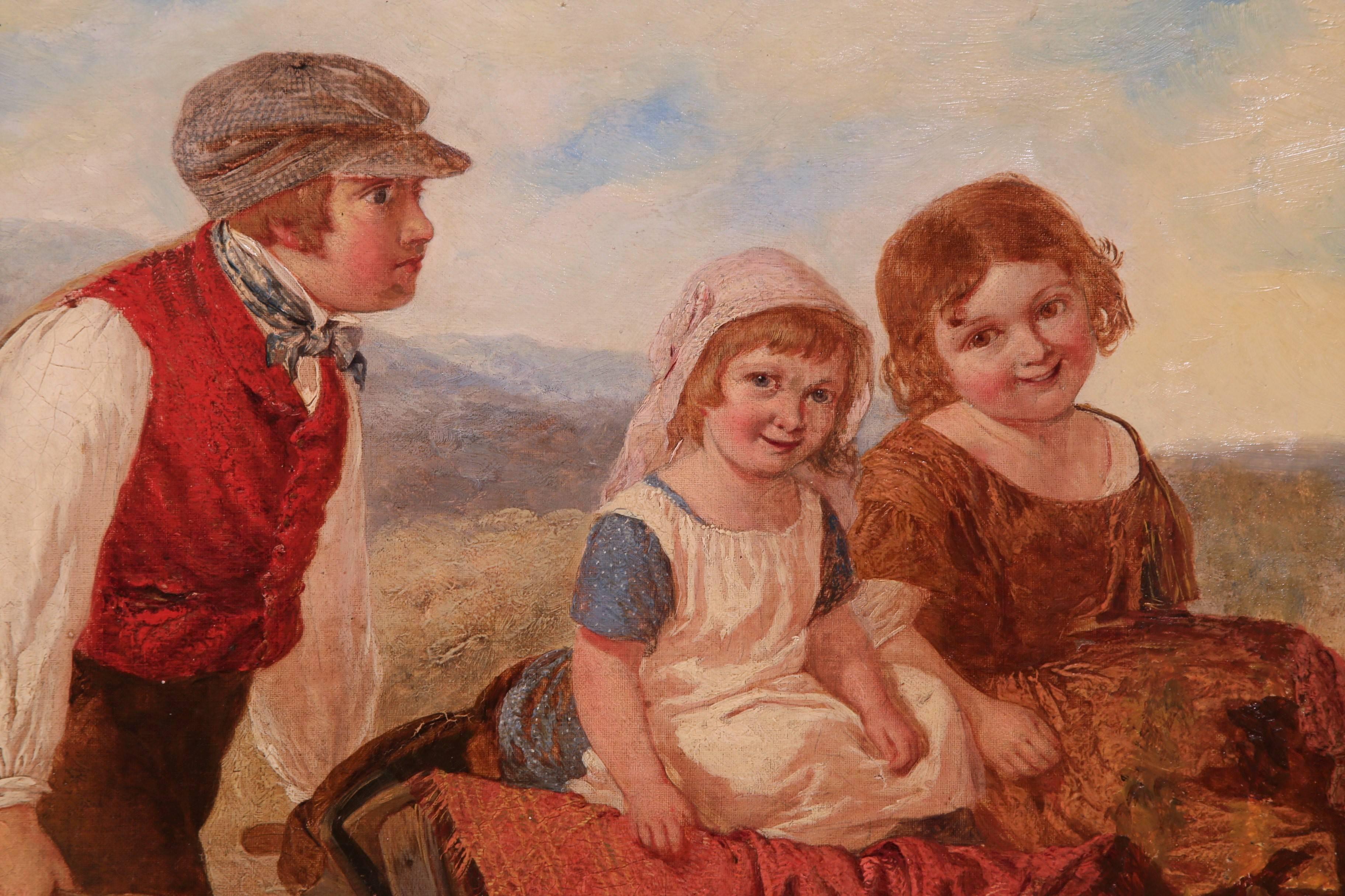 This fine antique painting from England is a bucolic scene that features three children in the countryside riding in a wheelbarrow. Painted circa 1860, the piece has a wonderful color palette, and figures with expressive faces. The painting is set