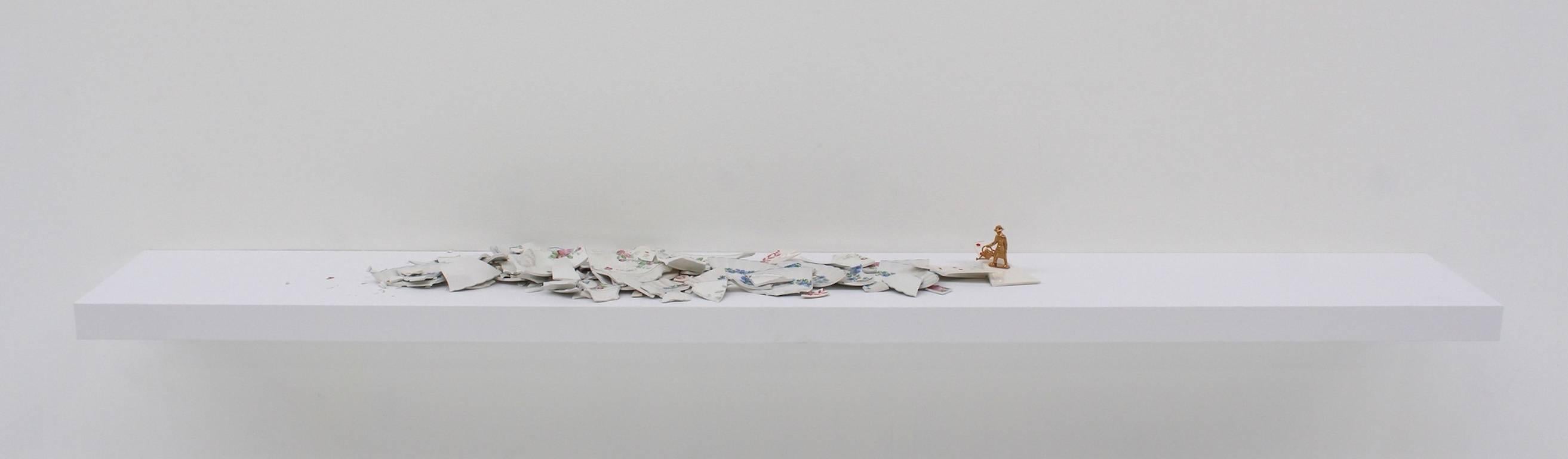 medium: ceramic fragments and figurine on painted shelf; small gardener figurine 
