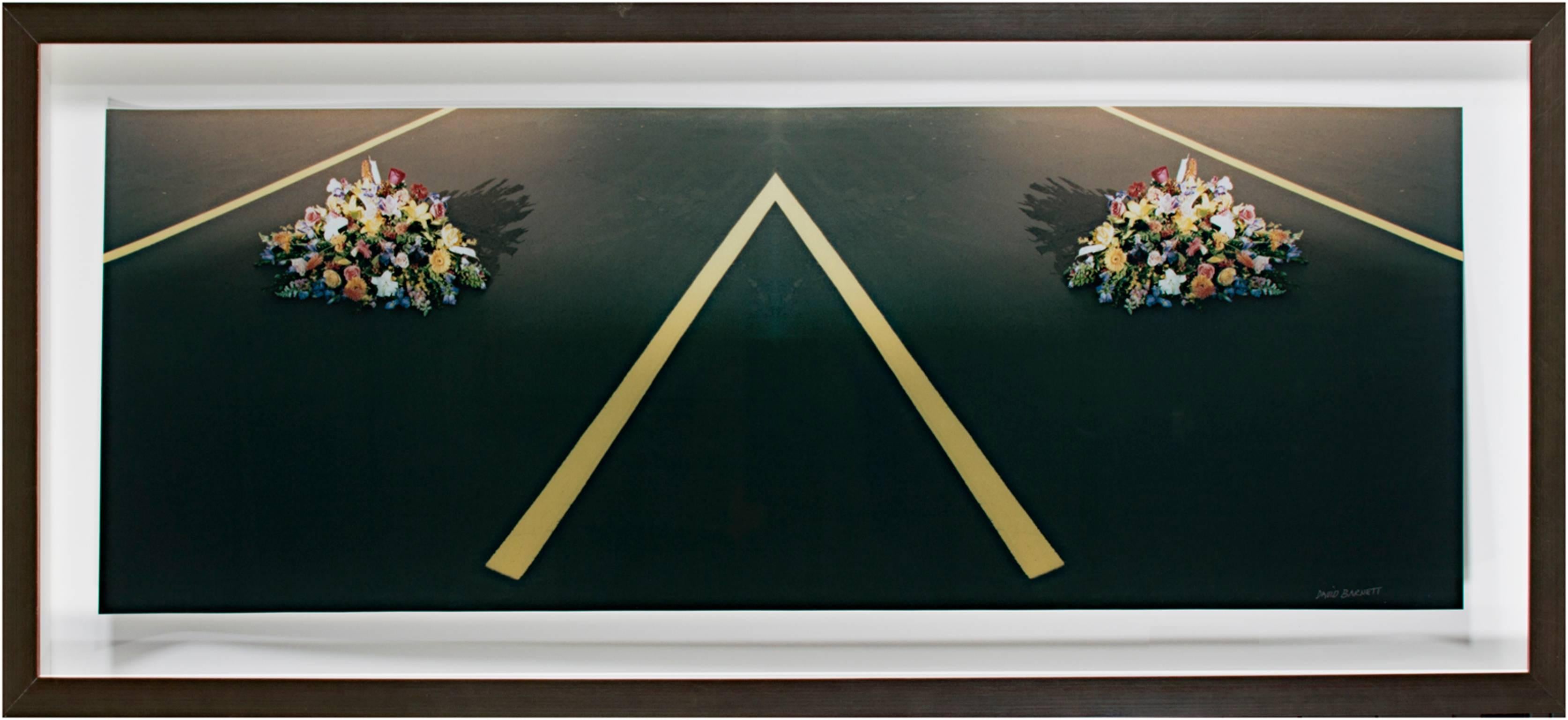 "Converged Final Parking Place" is a fine art photograph by David Barnett. It showcases yellow street lines delineating two converging parking spaces where bouquets of flowers sit. Signed lower right. 2002-2006.

14.375" x 40" framed

David Barnett