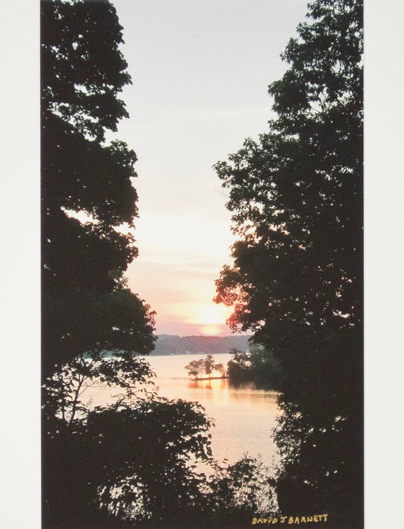 "Beaver Lake Sunrise" is a photograph printed on with archival ink and signed lower right by the artist David Barnett. It depicts a sunrise over Beaver Lake in Wisconsin in September. Much like Claude Monet, David Barnett also took serial images of