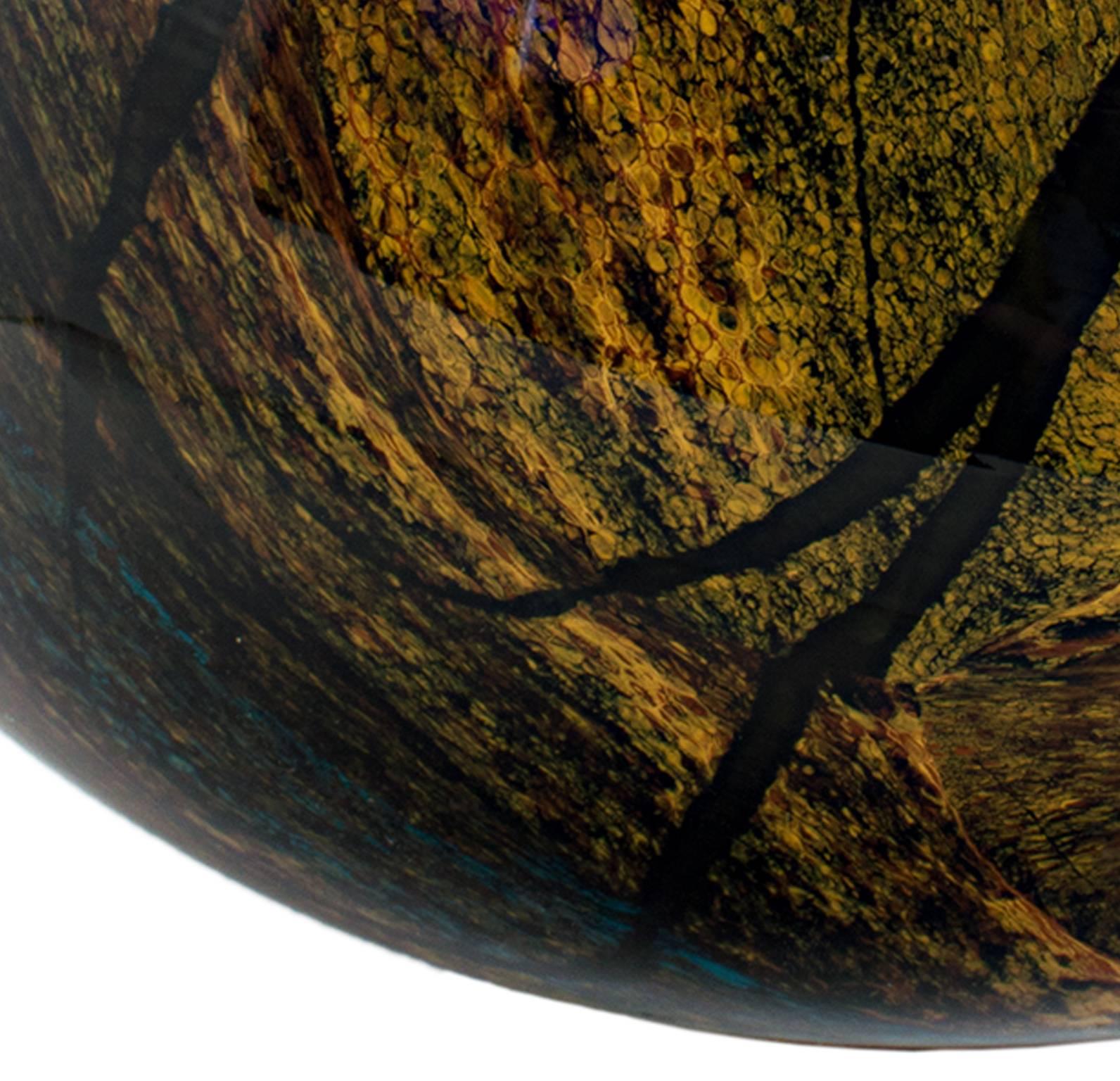 This piece is a hand blown glass egg by Ioan Nemtoi. The artist signed the glass egg. This piece features a natural color palette like yellow ocher, brown, olive green, and black. 

5 1/4