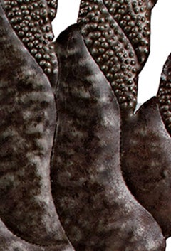 "Testa di ragazza con orecchini fantasia", acciaio firmato da Fred Cantava