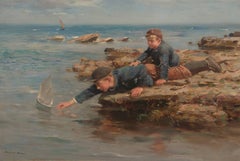 Boys Playing with their Boat on a Rocky Shore