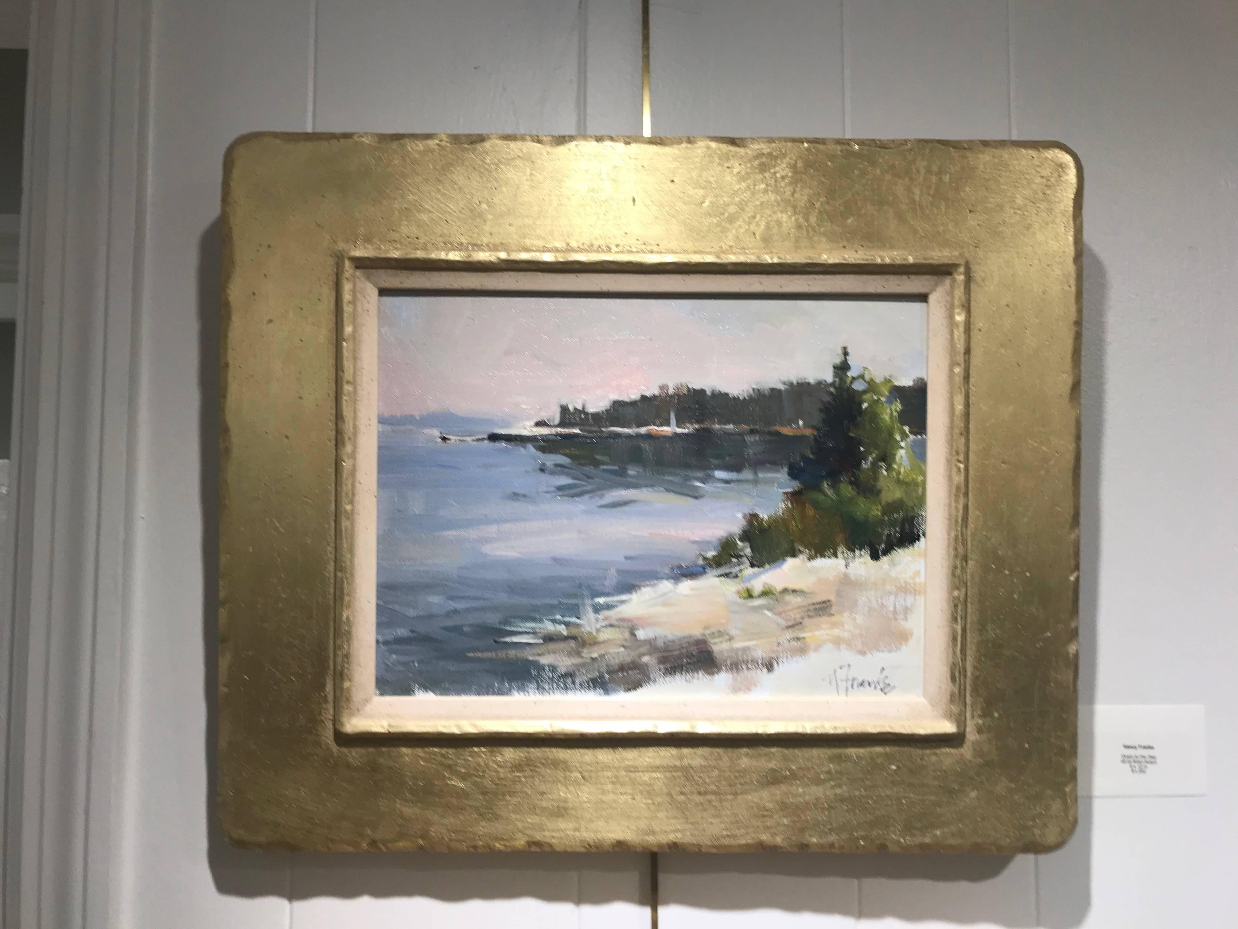 American artist Nancy Franke created this framed oil on linen board painting entitled 'Sparkling Morning in Maine' in 2017. Featuring a seaside scene, the artist chose a muted palette made of light browns, beiges, greens and blues to depict a coast