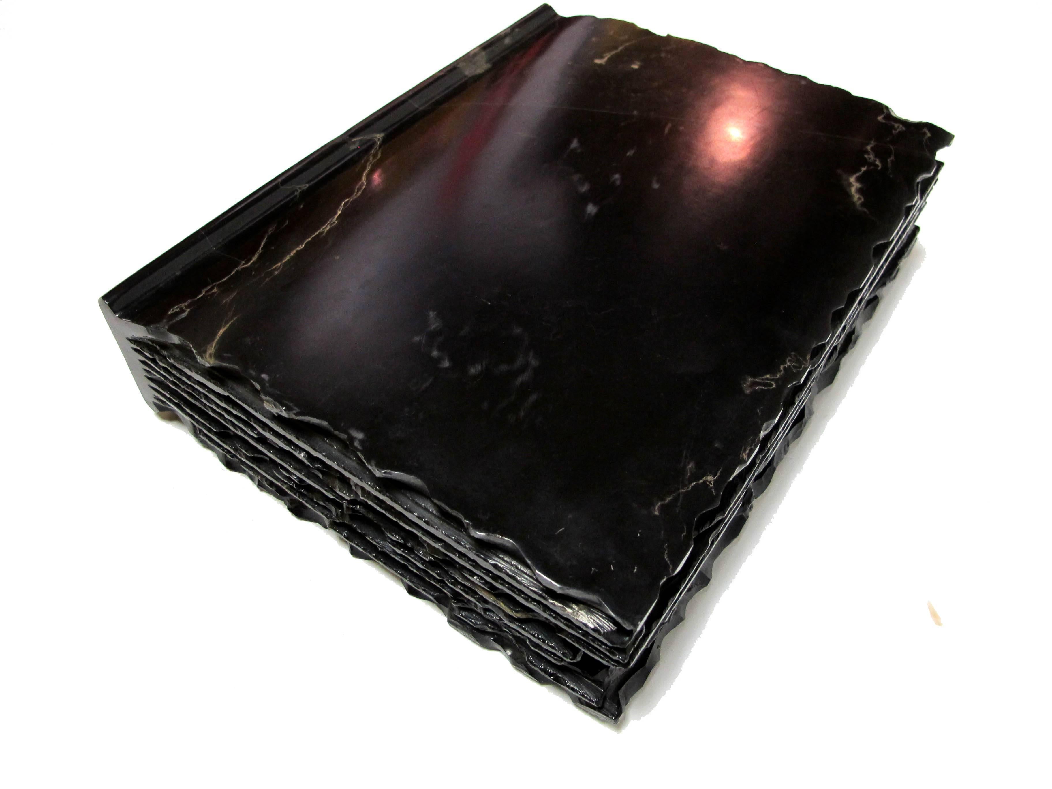 This is a gorgeous hand-carved black marble book. The marble is polished and with an amazing tactile feel. The weight and the feeling of the polished marble is the best. 

This piece is celebrates our connection to books and reminds us of the