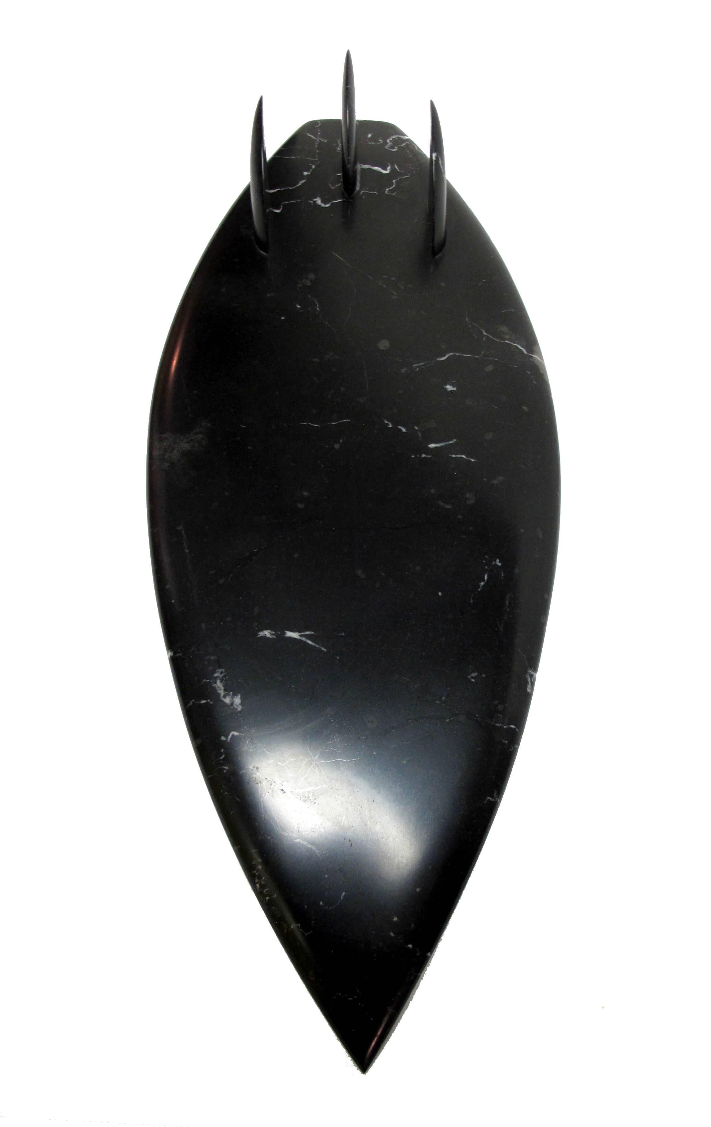 This is a gorgeous hand-carved black marble object. The marble is polished and with an amazing tactile feeling. The weight and the feeling of the smooth polished marble is the best. 

This piece celebrates our connection to natural materials and
