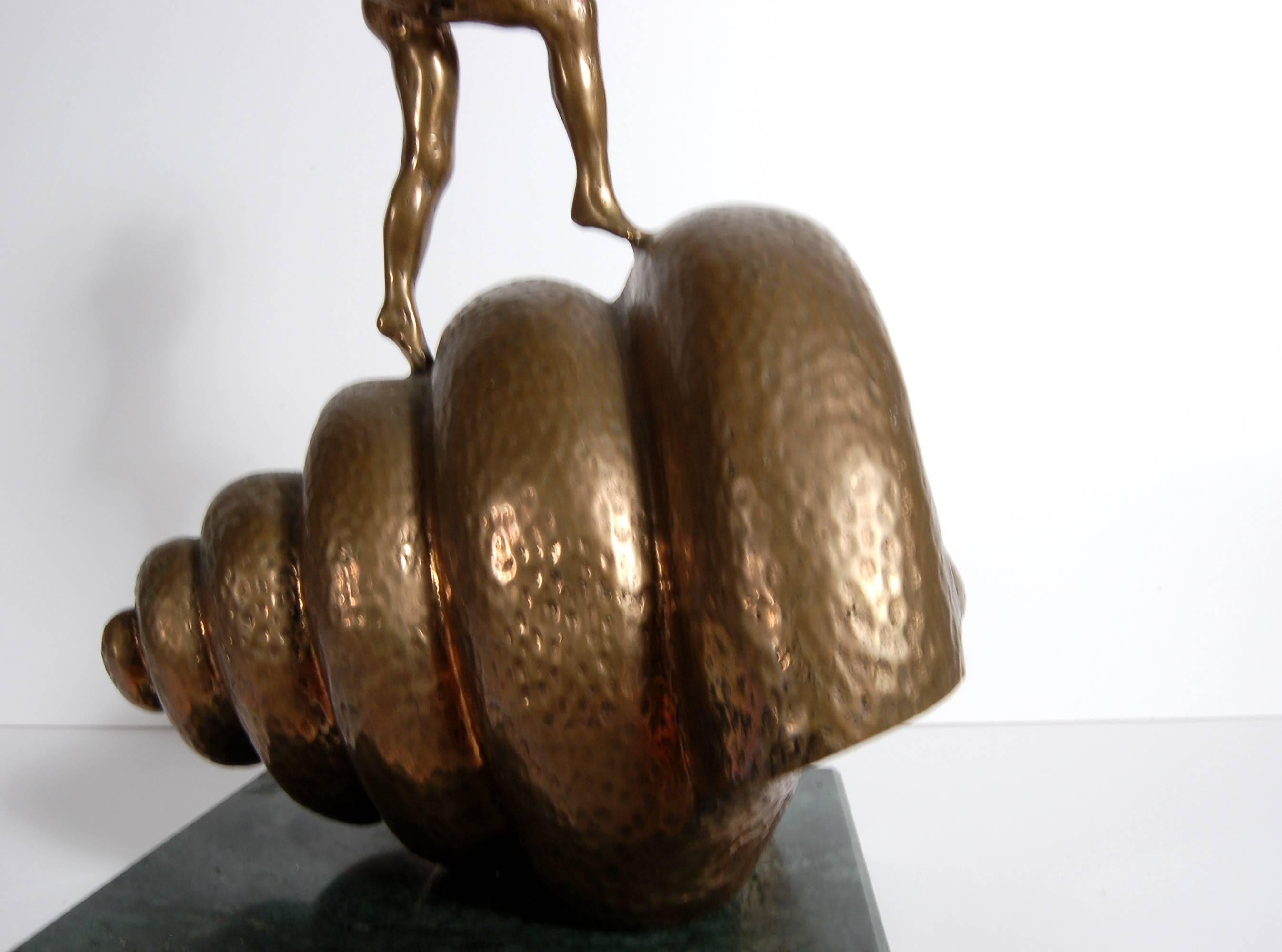 This artwork is is a bronze sculpture by Salvador Dali (Spanish surrealist, 1904-1989) titled, Nude Ascending a Staircase, depicting a female figurine perched atop an oversized seashell. An homage to Marcel Duchamp, the piece was created in 1973 and