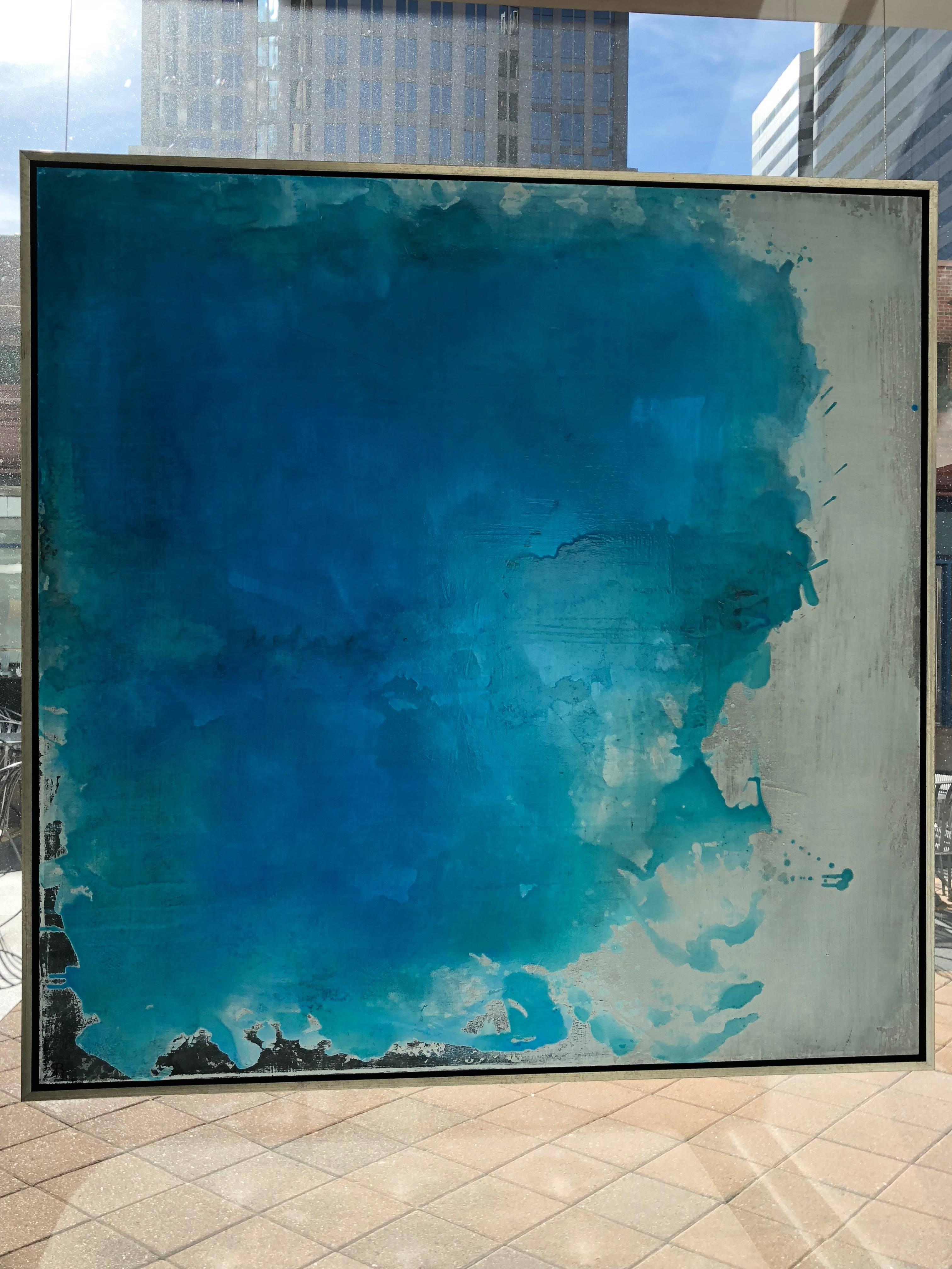 This vibrant mixed media piece gives bursts of rich turquoise, teal, white and grays that create a dream like feel. With the use of varying textures - moving between cracks and smooth surfaces- the artist creates an interesting and depth filled