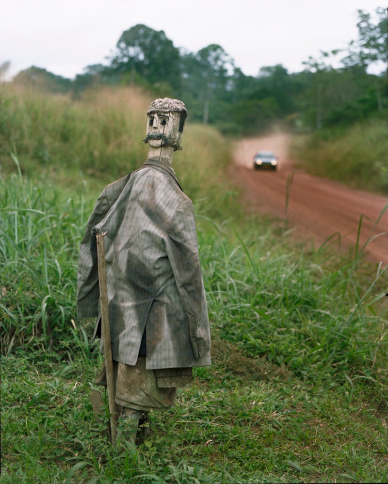 Sasha Bezzubov Portrait Photograph - Statue Outside of Medicine Man's House