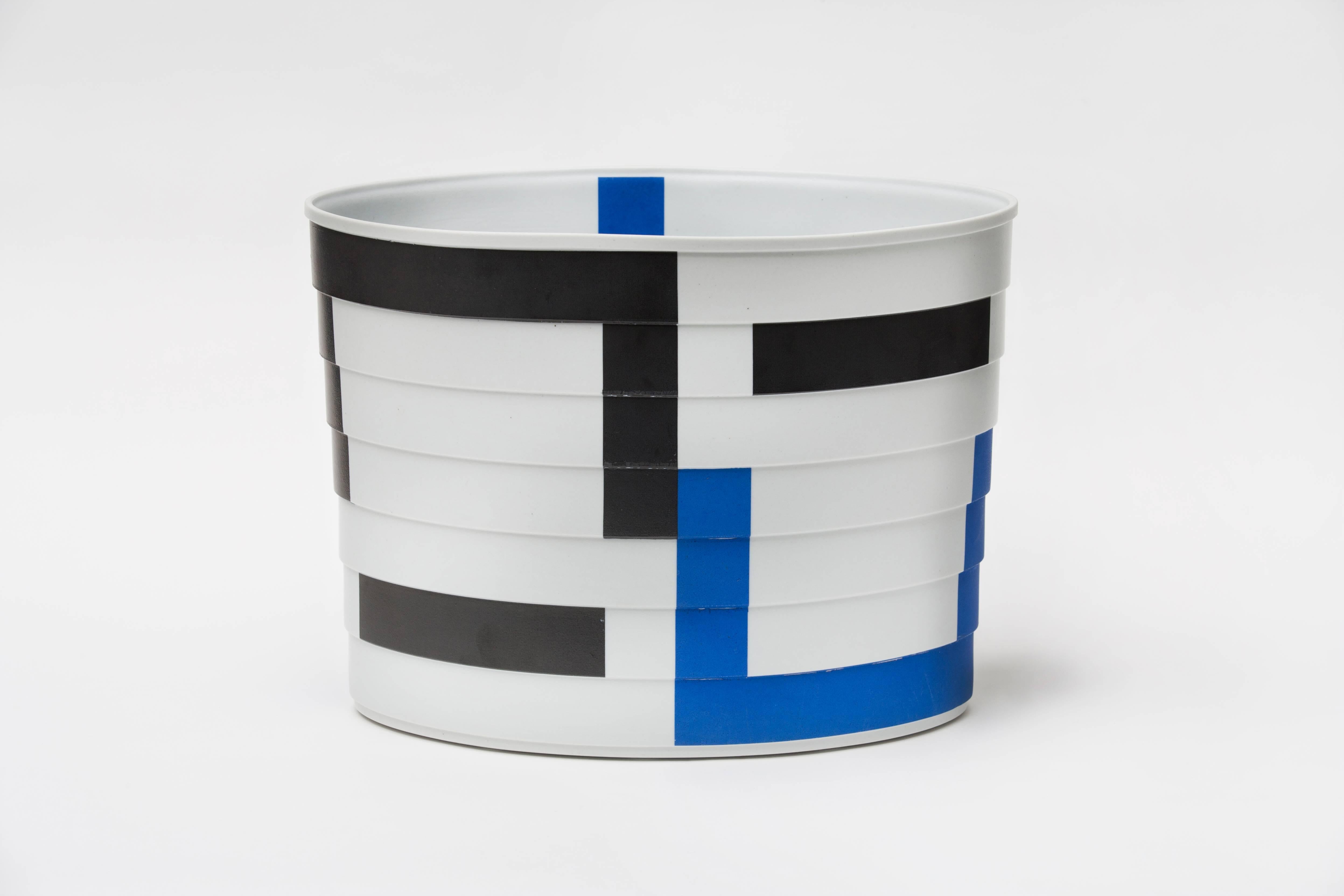 Bodil Manz is a ceramicist known for her use of ultra-thin, translucent eggshell porcelain to create distinctive cylindrical forms, anchored by bold, geometric abstractions in a style evocative of Russian Suprematism. Manz was born in Copenhagen in