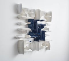 Blue and white ceramic porcelain wall sculpture installation by Maren Kloppmann