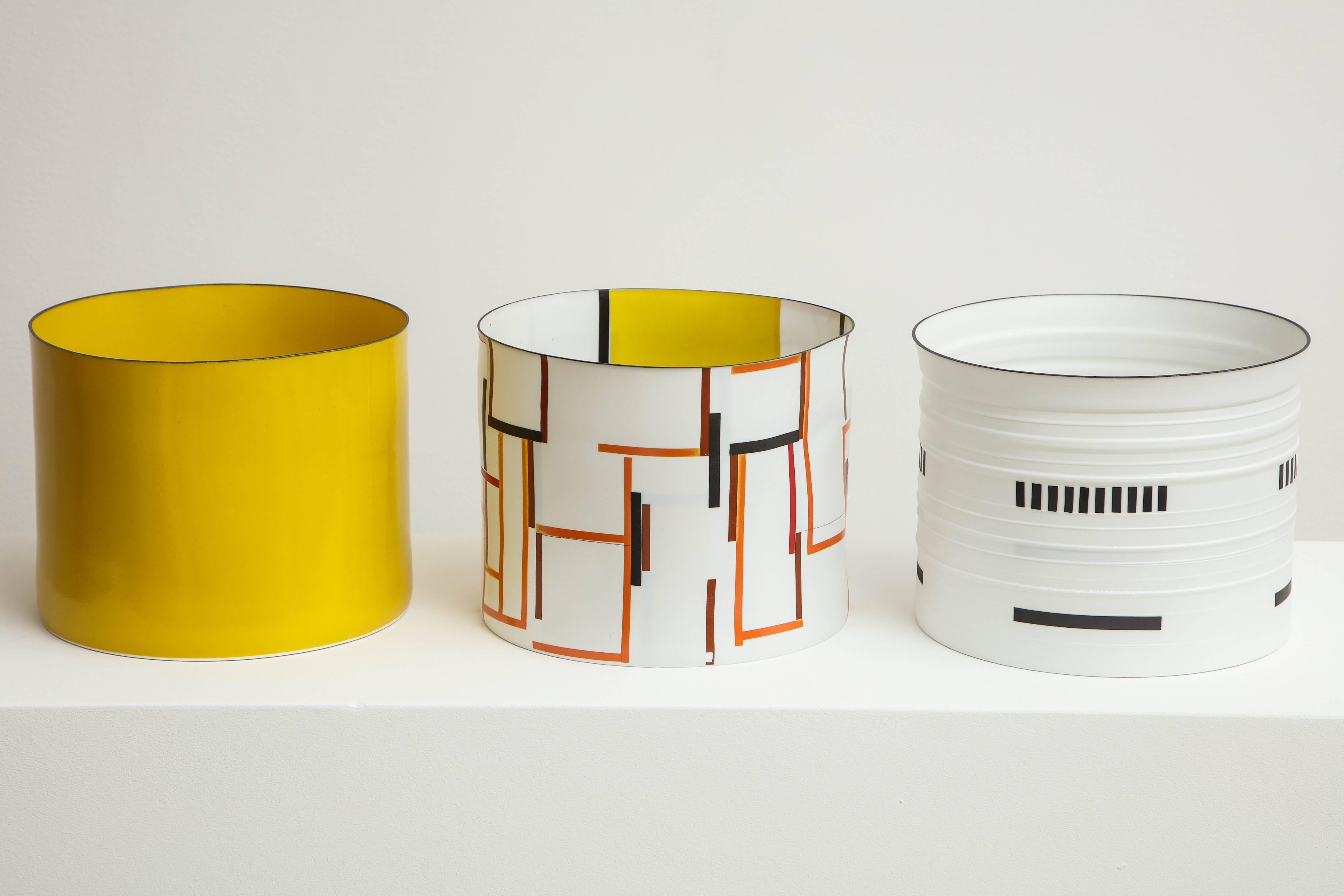 Bodil Manz is a ceramicist known for her use of ultra-thin, translucent eggshell porcelain to create distinctive cylindrical forms, anchored by bold, geometric abstractions in a style evocative of Russian Suprematism. Manz was born in Copenhagen in