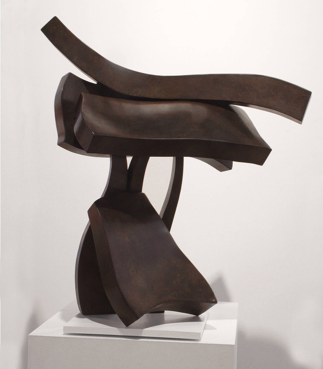 This pedestal bronze sculpture with a medium dark patina appears to be dancing -although it is abstract. Hans Van de Bovenkamp's work is inspired by myths, the collective consciousness, and subliminal learning. “I like dreams, myths and mythology,"