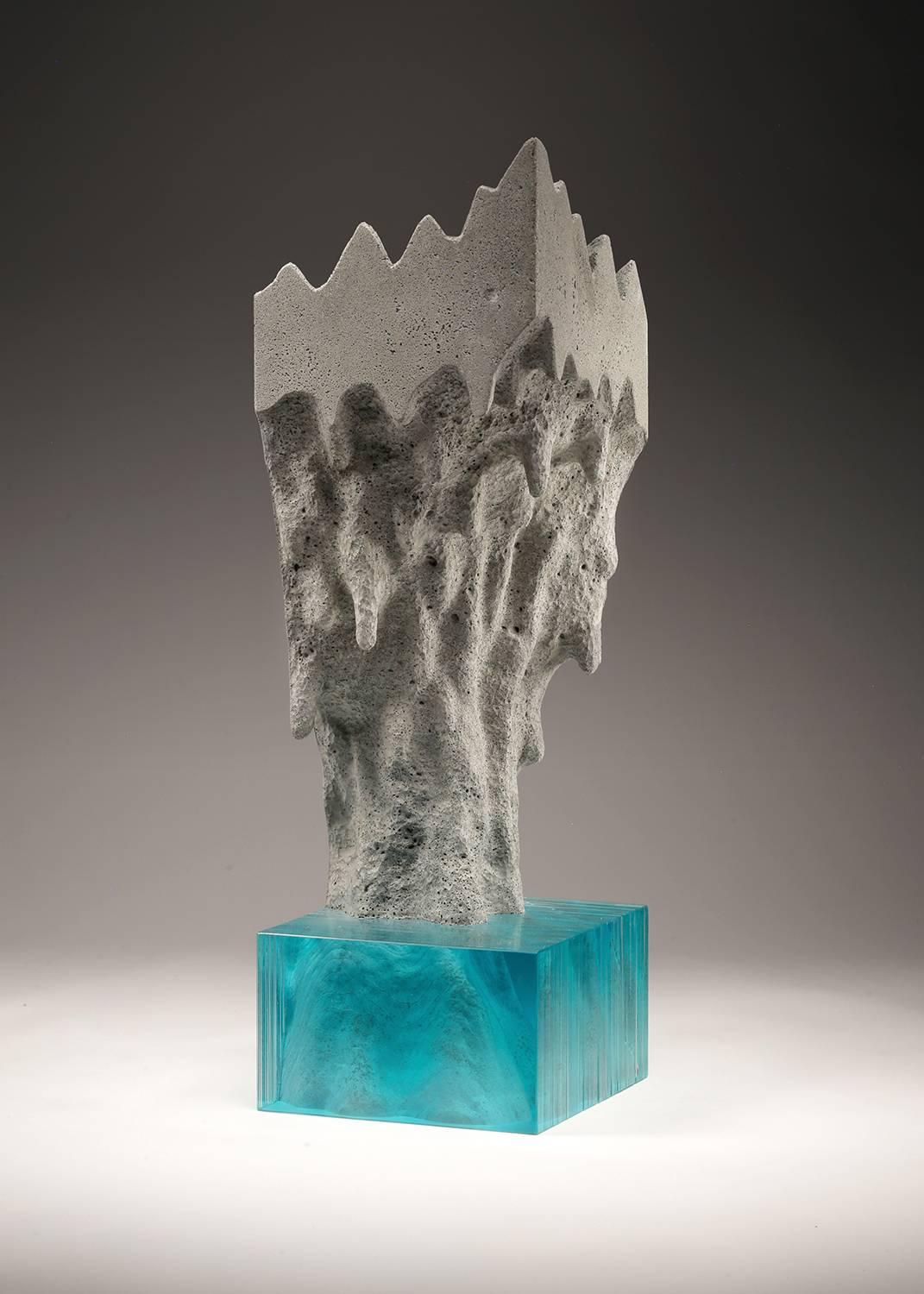 Laminated float glass, concrete, and bronze detail

In this piece, Young depicts a deep dual-layered cliff of the deep ocean with a peaceful oasis hiding down below. The artist draws his concept then cuts each sheet of glass by hand and creates a