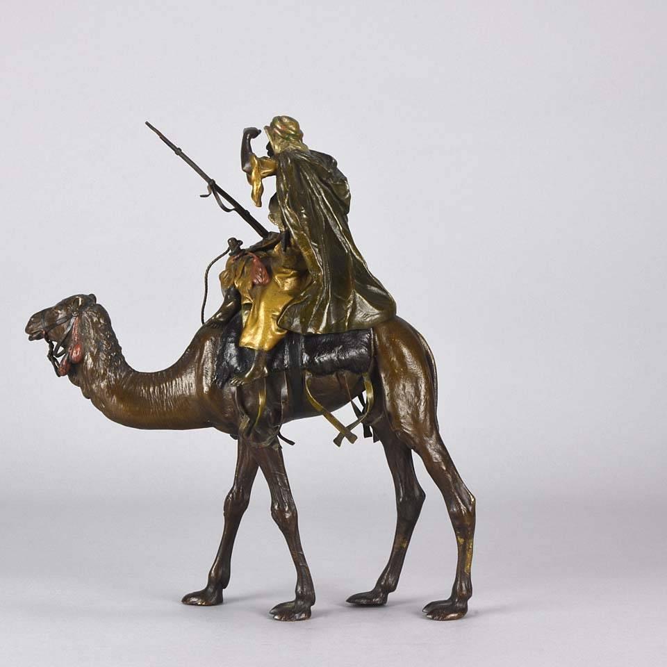 Very impressive large cold painted Austrian Bronze group of an Arab warrior holding his rifle and looking into the distance whilst mounted on his camel, carrying various accoutrements. The detailed surface with fine hand chased workmanship