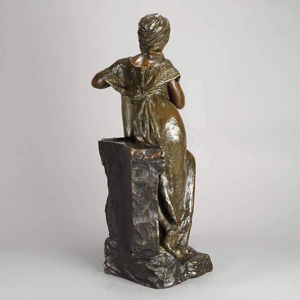 A very fine and rare full length bronze figure of a young beauty leaning against a well wall resting her arm upon a water urn in deep contemplation, the surface of the bronze with excellent tri-colour patina and good hand finished detail. Signed