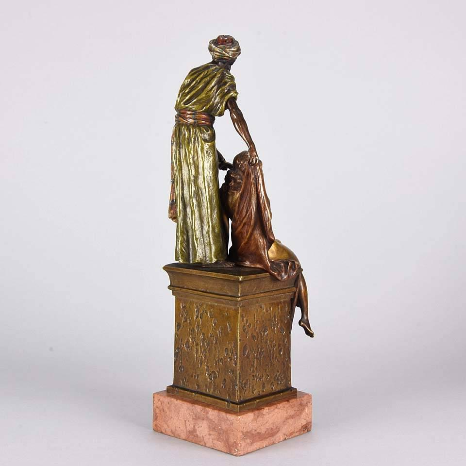 Impressive cold painted Orientalist bronze group of an Arab Slave Trader proudly showing off his goods for sale in the form of a beautiful young woman seated on the plinth. The bronze has excellent original cold painted colours and fine intricate