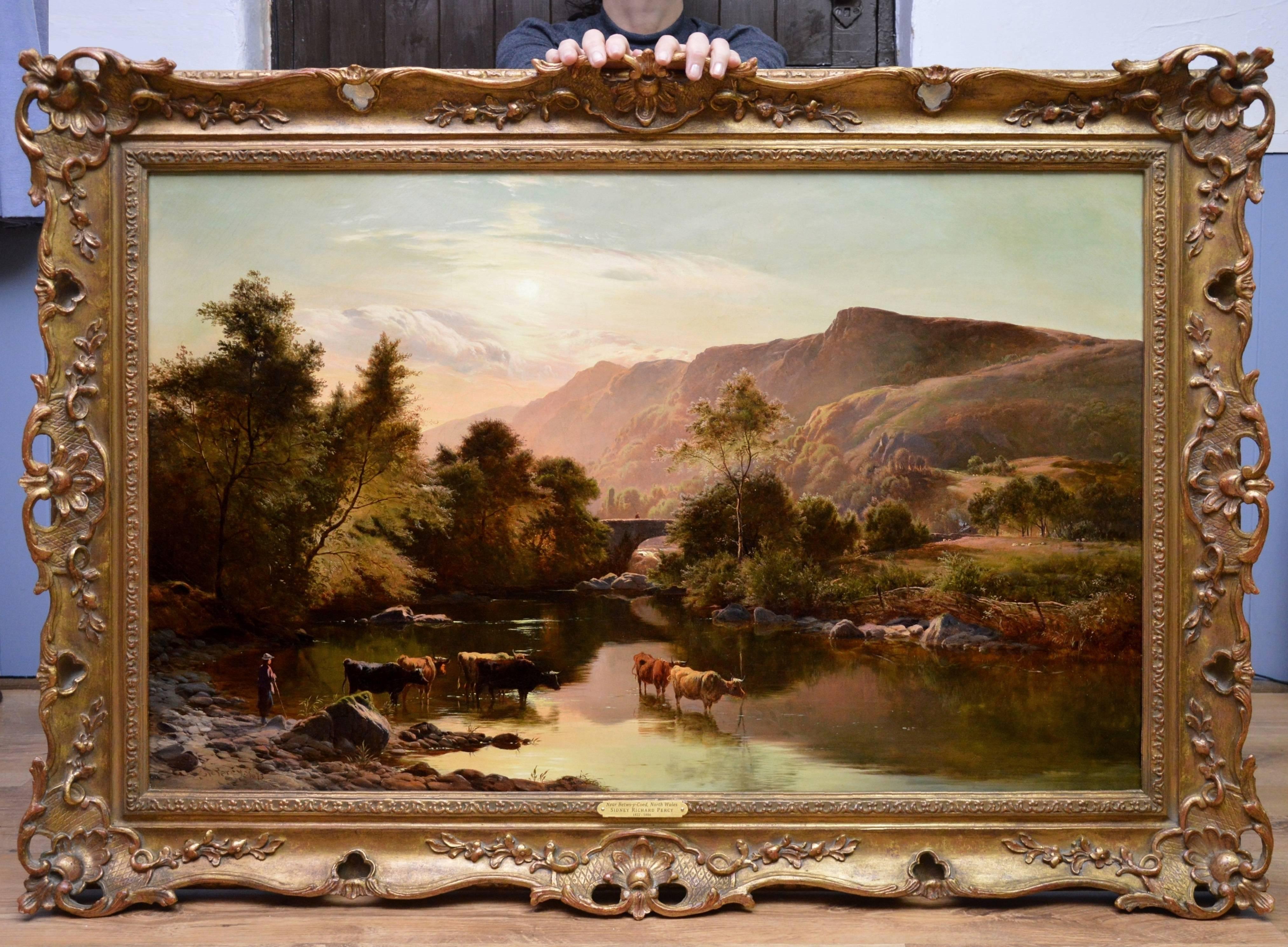 This is a very fine large 19th century oil on canvas depicting cattle watering at the riverside in an extensive mountainous summer landscape ‘Near Betwys-y-Coed, North Wales’ by the important Victorian landscape painter Sidney Richard Percy